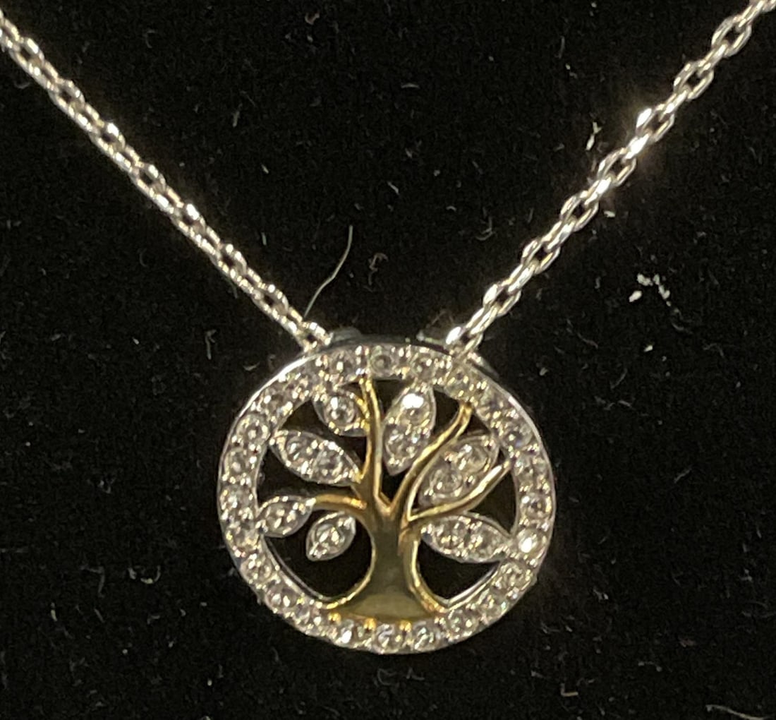 Swarovski Touchstone Crystal Tree Necklace: Touchstone by Swarovski silver tone pendant necklace with tree motif pendant and Swarovski crystal decoration. Signed on hang tag. Drop length approx. 8 inches. Some surface wear including scratching 