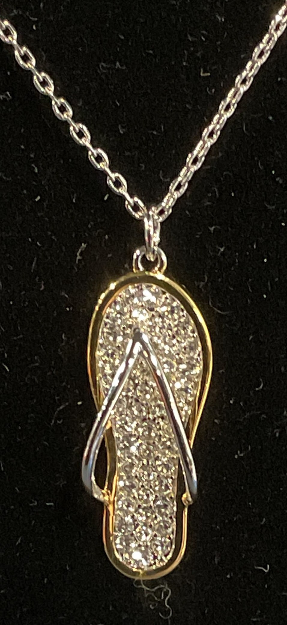 Swarovski Touchstone Crystal Sandal Necklace: Touch by Swarovski silver tone pendant necklace. Sandal motif pendant with Swarovski crystal decoration. Signed on hang tag. Drop length approx. 8.75 inches. Some surface wear including scratching obs