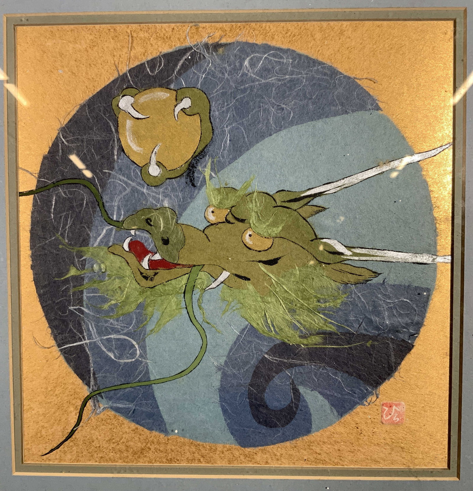 Framed Asian Style Dragon Head Collage Painting: Paper collage and painting on paper. Signed in lower right corner with Hanko. Subject depicts a dragon head with a clawed hand grabbing a gold orb. Framed in a gilt wooden frame. Frame measures approx