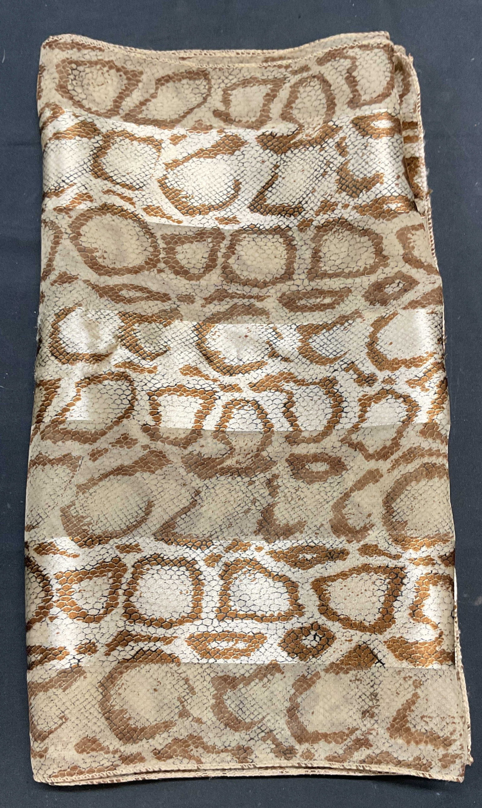 Tan Snakeskin Print Scarf: Tan snakeskin print scarf. 100% polyester. Measures approx. 58 inches long. Some wear to material consistent with exposure. Ladies scarf, ladies accessories, ladies fashion accessories, ladies wearabl