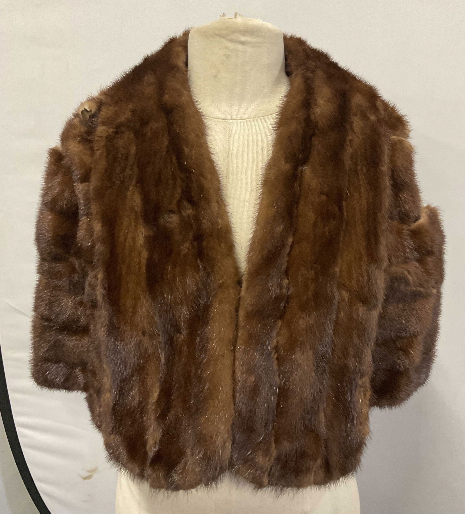 Vintage Brown Fur Cape: Vintage brown fur cape. Possibly mink. Name monogrammed on lining. Measures approx. 18 inches across shoulders, 16 inches across chest, 18 inches from shoulder to hem. Wear to material including teari