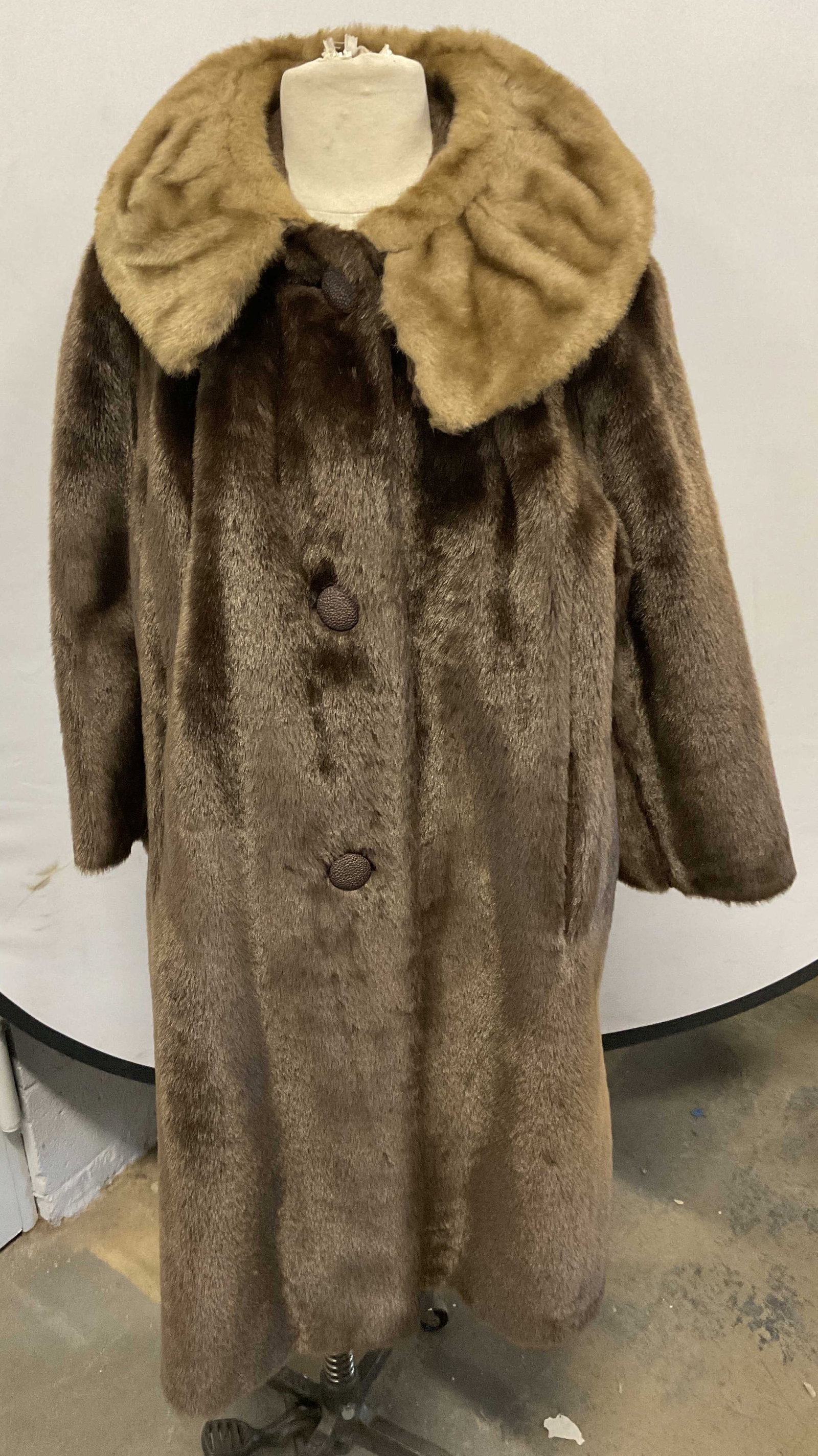 Vintage Brown Faux Fur Coat: Vintage Brown faux fur coat with tan faux fur collar. Front button closure and pockets. Measures approx. 21 inches across chest, 40 inches from shoulder to hem. Some wear to material consistent with e