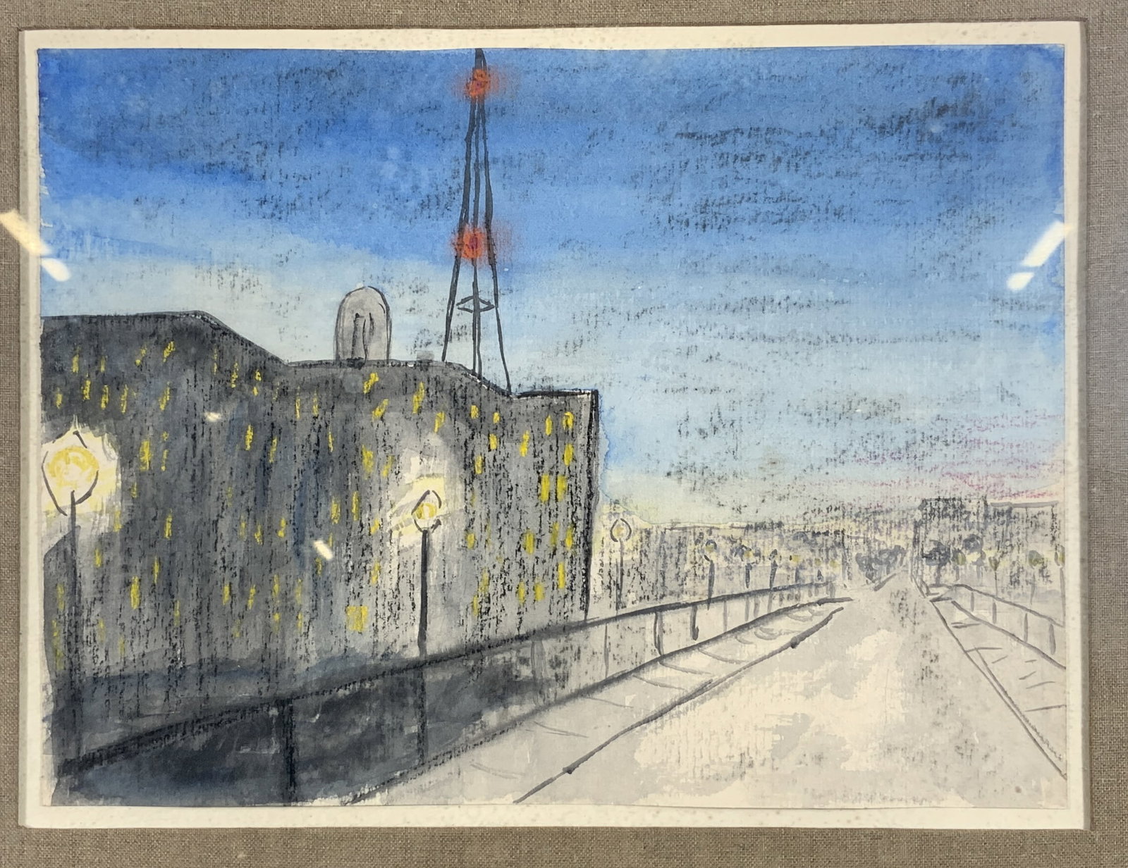 Framed Street Lit Road Watercolor on Paper: Watercolor and pastels on paper. Subject depicts a street lit road next to a building with a storm tower on top. Framed in a gilt wooden frame. Frame measures approx. 18.5 W x 16 H in. Window measures