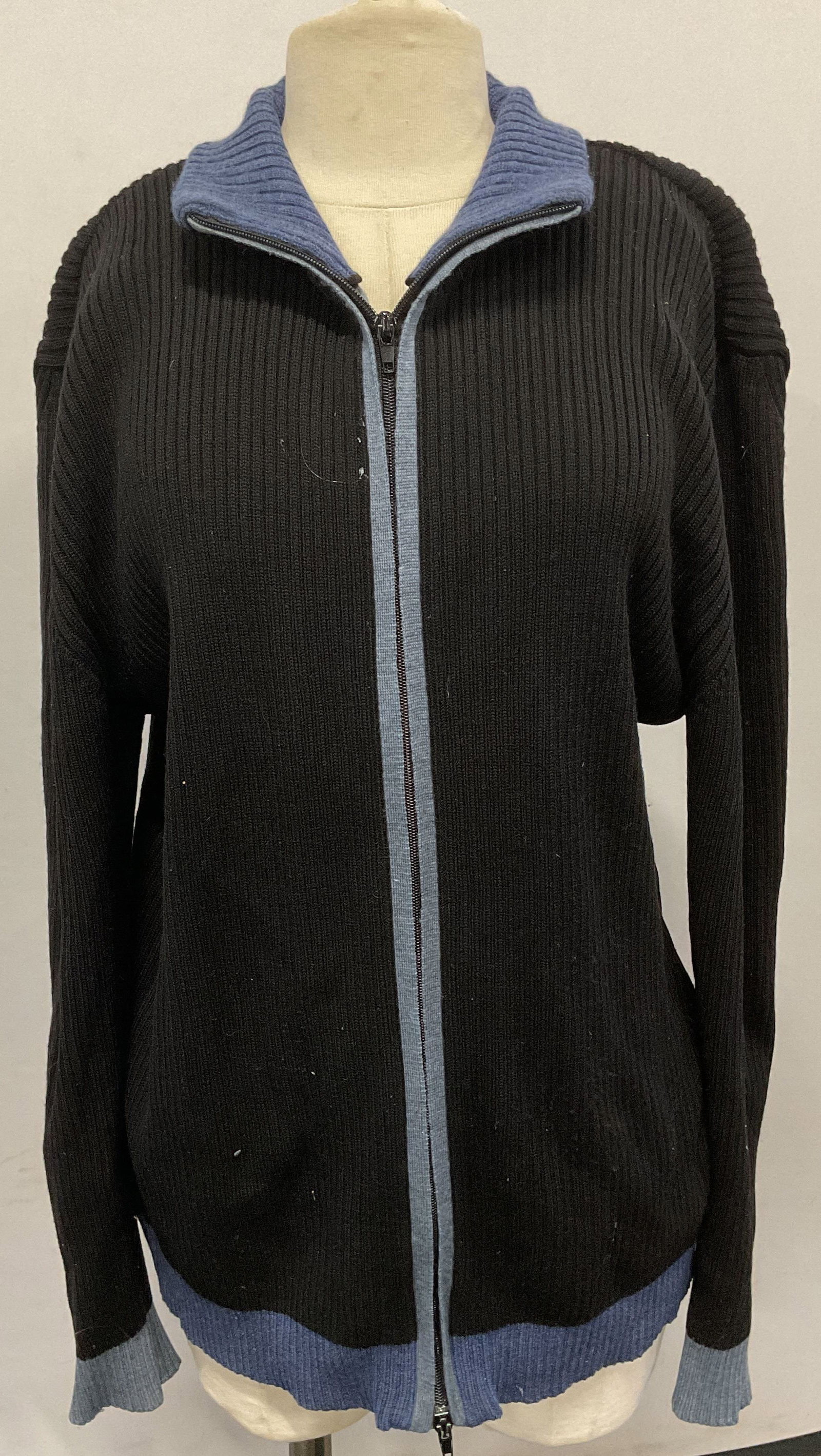 Barneys Black Merino Wool Zip Up Sweater, Italy: Barneys black and blue trim ribbed knot merino wool zip up sweater. Made in Italy. Size xl. Some wear to material consistent with exposure. Barneys, Barneys sweater, mens designer sweater, mens merino