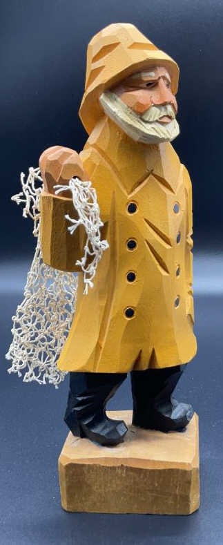 Hand carved vintage wood Fisherman w Net: Folk art figural of fisherman in yellow parka, marching yellow hat and black boots, holding a piece of fishing net, whimsical old salt figural measures app 11 inches ht, 4.5 inches width, depth app 3 