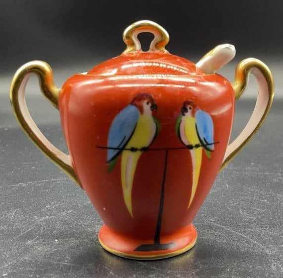 Hand Painted Noritake Sugar bowl w Spoon: Hand painted brick orange toned sugar bowl, with two birds, gold accents, and matching spoon, underside reads Noritake Japan, hand painted measures ht app 3.5 inches width 4 inches, depth app 2.5 inch