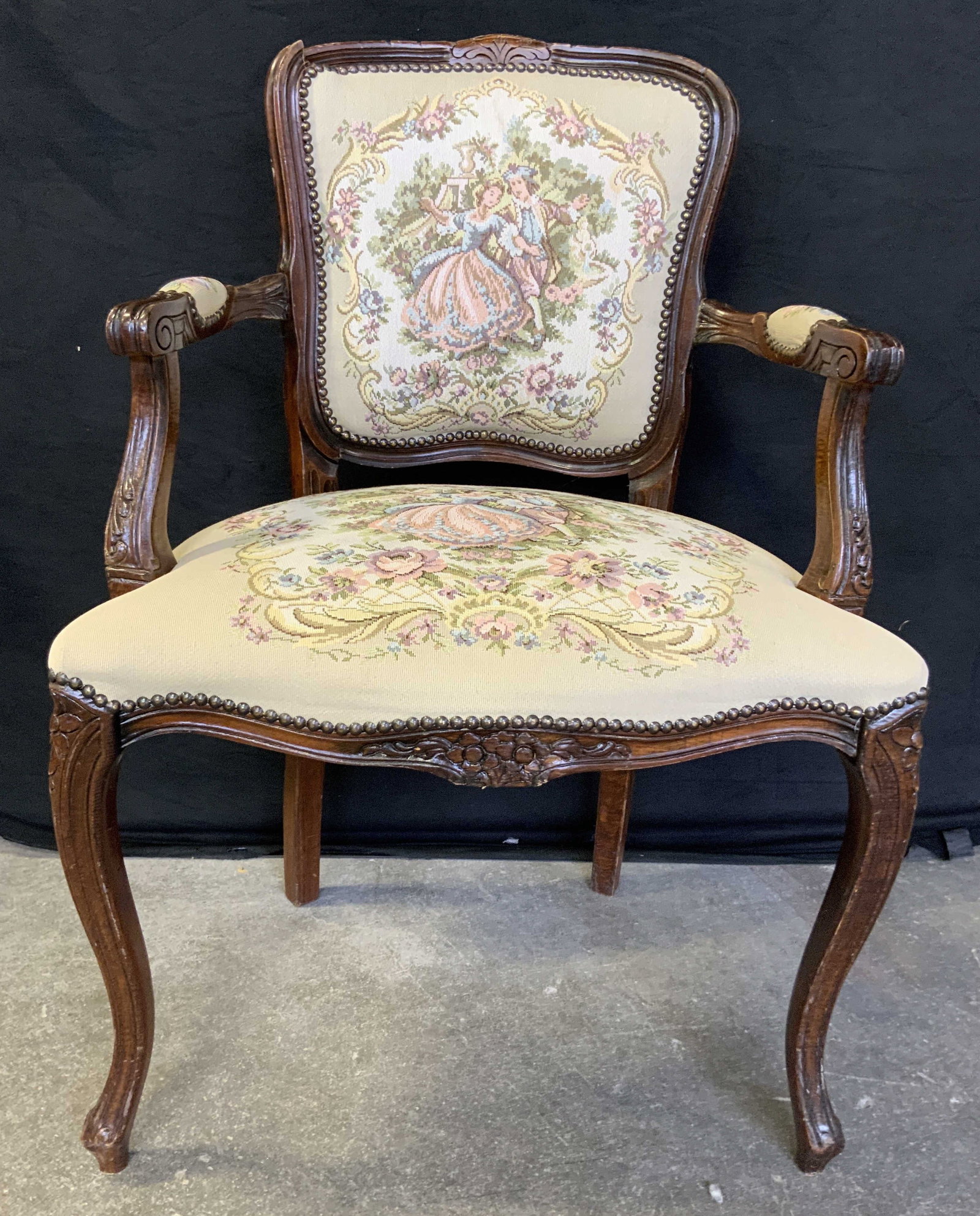 Vtg Victorian French Louis XV Style End Chair: Chair has needlepoint upholstery with floral, leaf & figural detail. Chair has nail head detail at edges. Piece has carved wooden floral detail writhing frame. Measures approximately 37 inches tall 24
