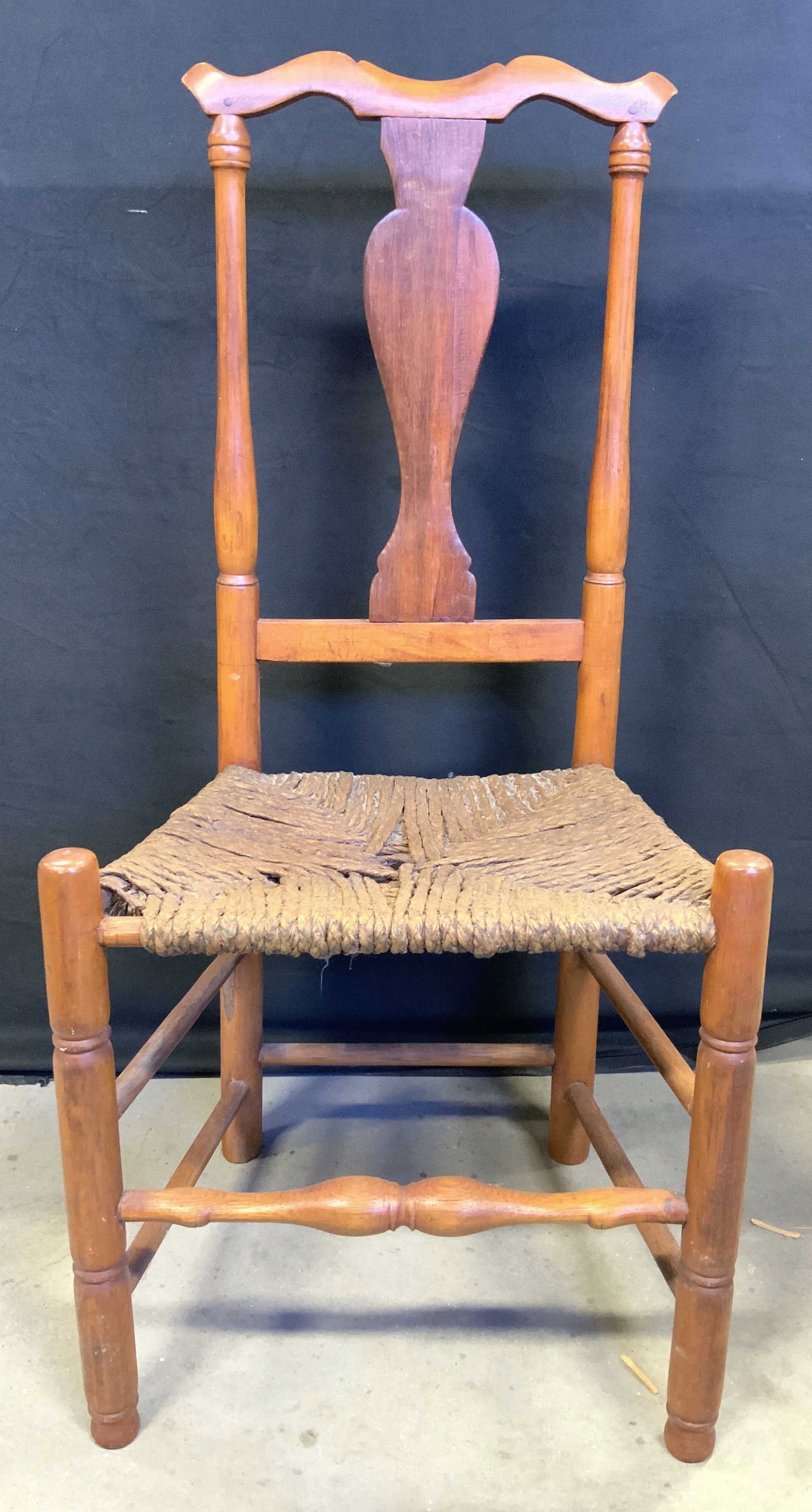 Vintage Carved Wooden Side Chair W Rush Seat: Chair is vintage & wooden. Piece is light brown toned with carved urn form backrest. Chair has Rush seat & box stretcher in between legs. Chair measures approximately 38.5 inches tall 19 inches wide 1