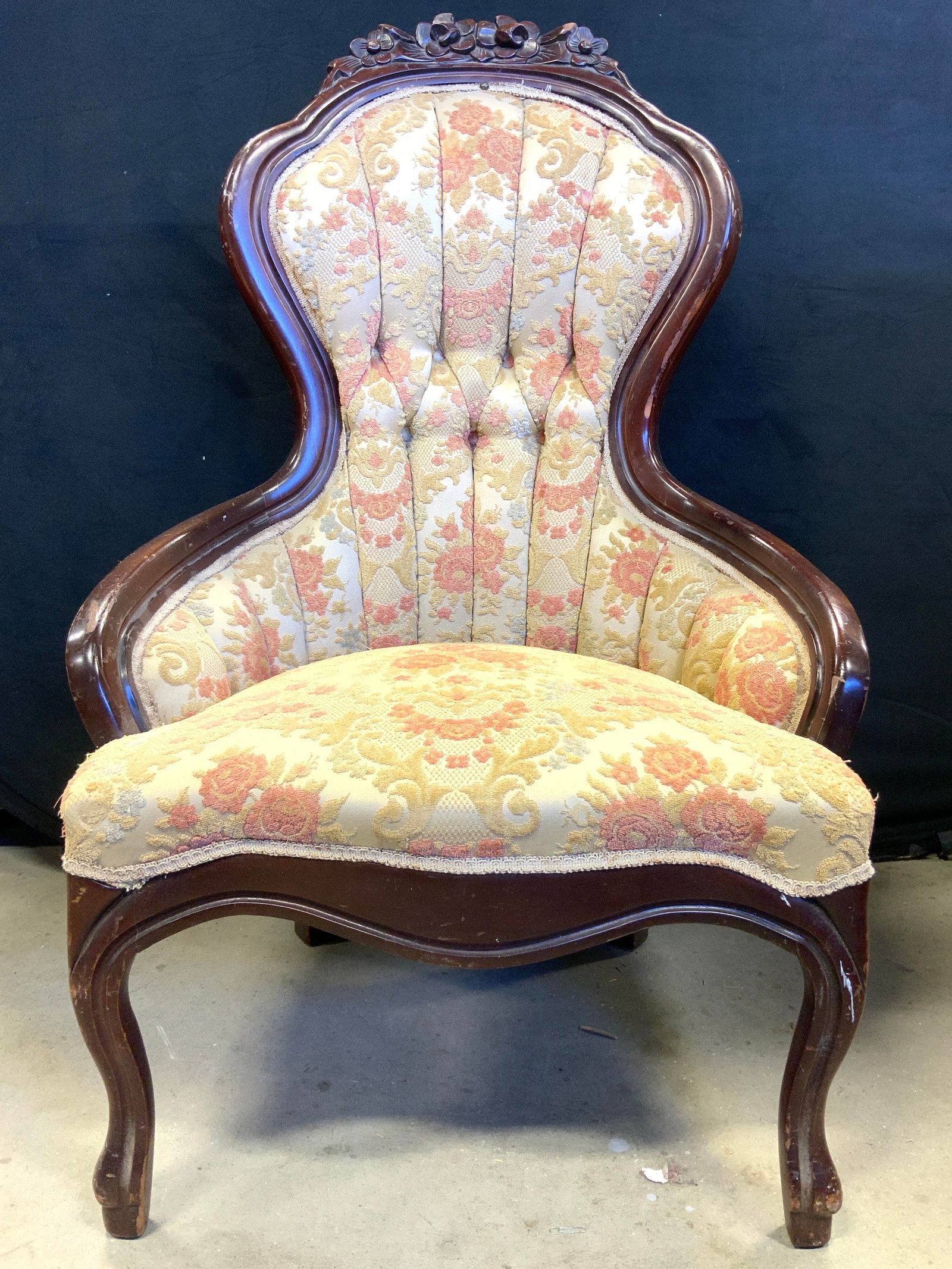 American Furn Galleries Vtg Victorian Style Chair: Tag on underside reads AMERICAN FURNITURE GALLERIES. Chair is vintage and wooden. Piece has intricate raised floral, scroll, & leaf motif detail. Backrest has tufting. Top of piece has carved floral &