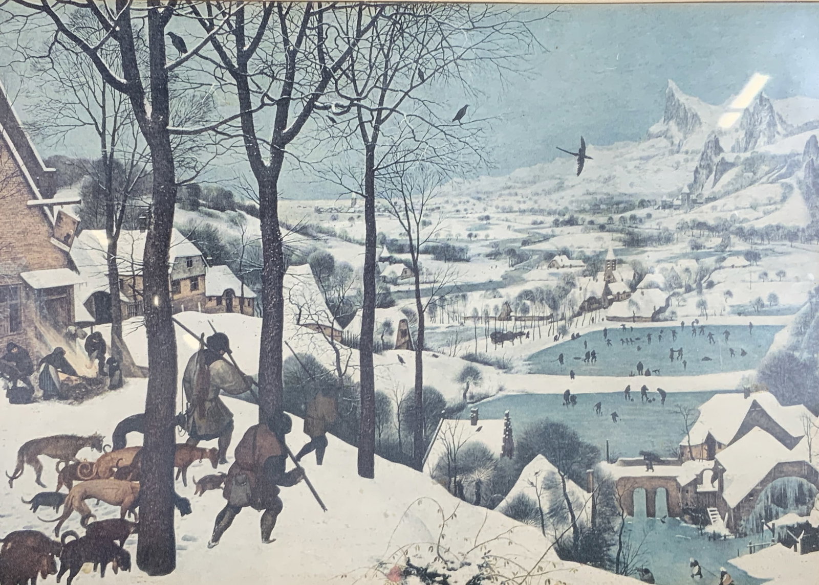 After Pieter Bruegel Hunter in the Snow Lithograph: Lithograph on paper. Art after Pieter Bruegels Hunters in the Snow. Subject depicts a group of hunters walking back to town from a hunting trip with a group of dogs. Framed in a black wooden frame. Fr