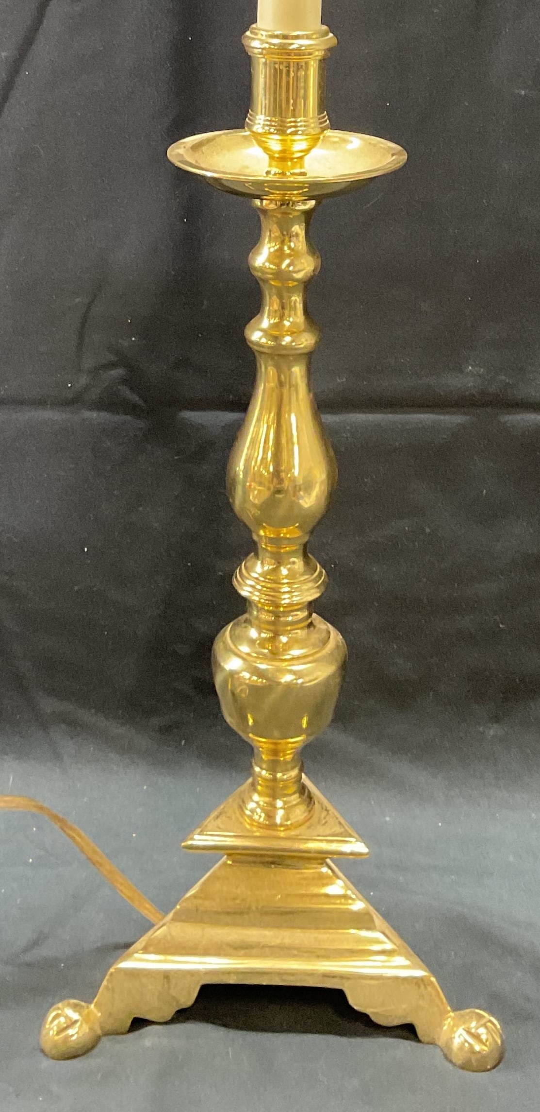 Vintage Gold Tone Table Lamp: Vintage gold tone table lamp with tripod footed base. Measures approx. 6.5 x 25 inches including finial. Some surface wear including scratching observed. Not tested for function. Lamp, gold tone lamp,