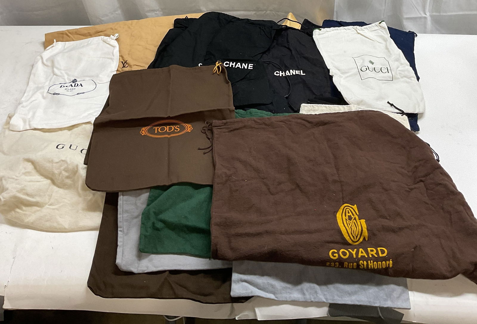 Group Lot Luxury Designer Dust Bags, Chanel +: Group lot of luxury designer dust bags. Some pieces includes Chanel, Goyard, Kieselstein Cord, Prada, Gucci, Louis Vuitton, Fendi, and more. Largest measures approx. 20 x 20 inches. All pieces have so