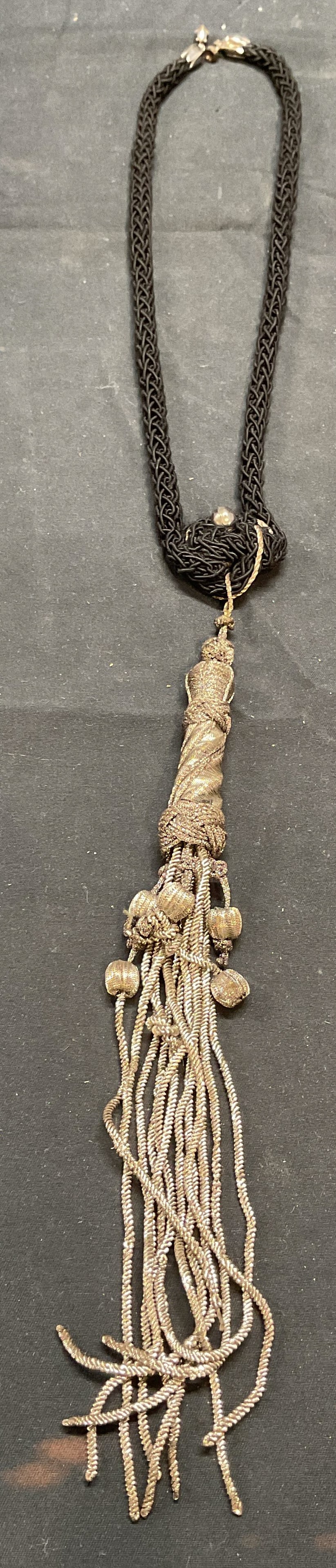 Black & Silver Cord Pendant Necklace: Black and silver tone cord necklace with tassel pendant. Drop length approx. 11 inches. Pendant drop approx. 9.5 inches. Some surface wear including blemishes observed. Jewelry, estate jewelry, costum