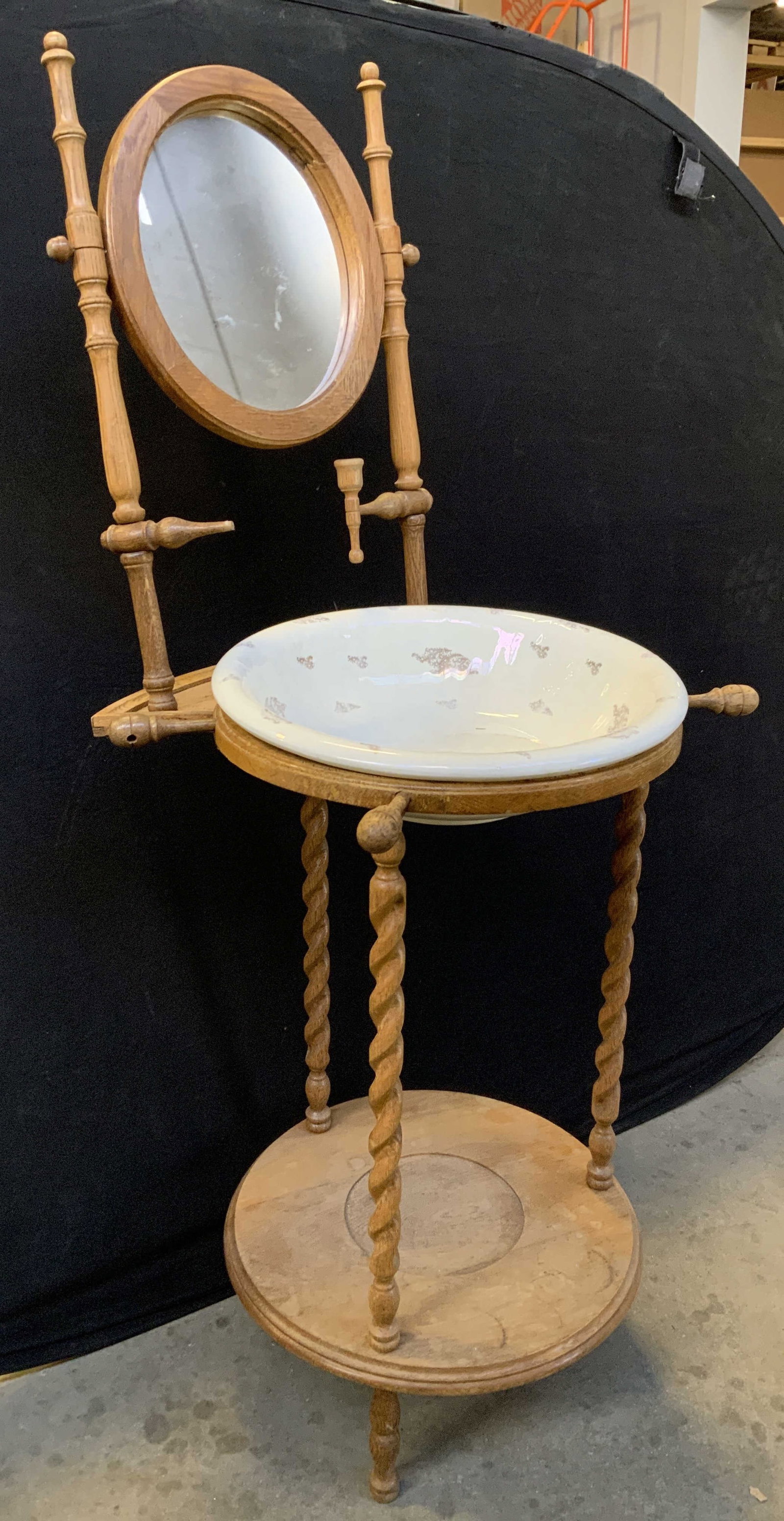 Antique Wooden Victorian Wash Stand: Wash stand appears to be antique possibly vintage. Piece is tan toned and wooden. Wash stand has porcelain bowl vessel insert. Wash stand has barley twist supports. Piece measures approximately 52 inc
