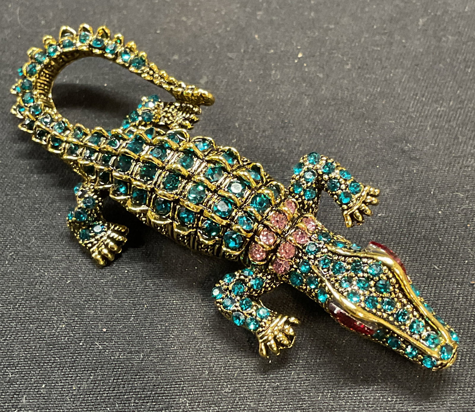 Vintage Gold Tn Crystal Alligator Brooch/Pendant: Vintage gold tone alligator motif brooch/pendant with blue, pink, and red crystal decoration. Hinge pin and bail on underside. Measures approx. 3 x 1 inches. Some surface wear including scratching obs