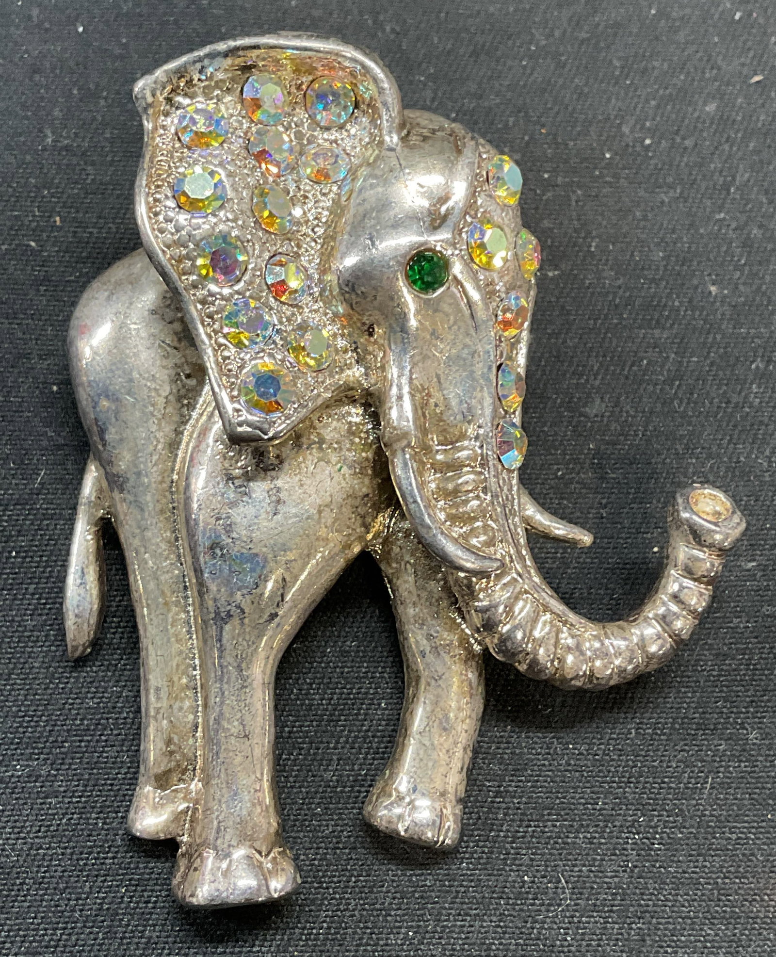 Vintage Silver Tone Crystal Elephant Brooch: Vintage silver tone elephant motif brooch with crystal decoration. Hinge pin on underside. Measures approx. 2 x 1.75 inches. Some surface wear including scratching observed. Jewelry, estate jewelry, c