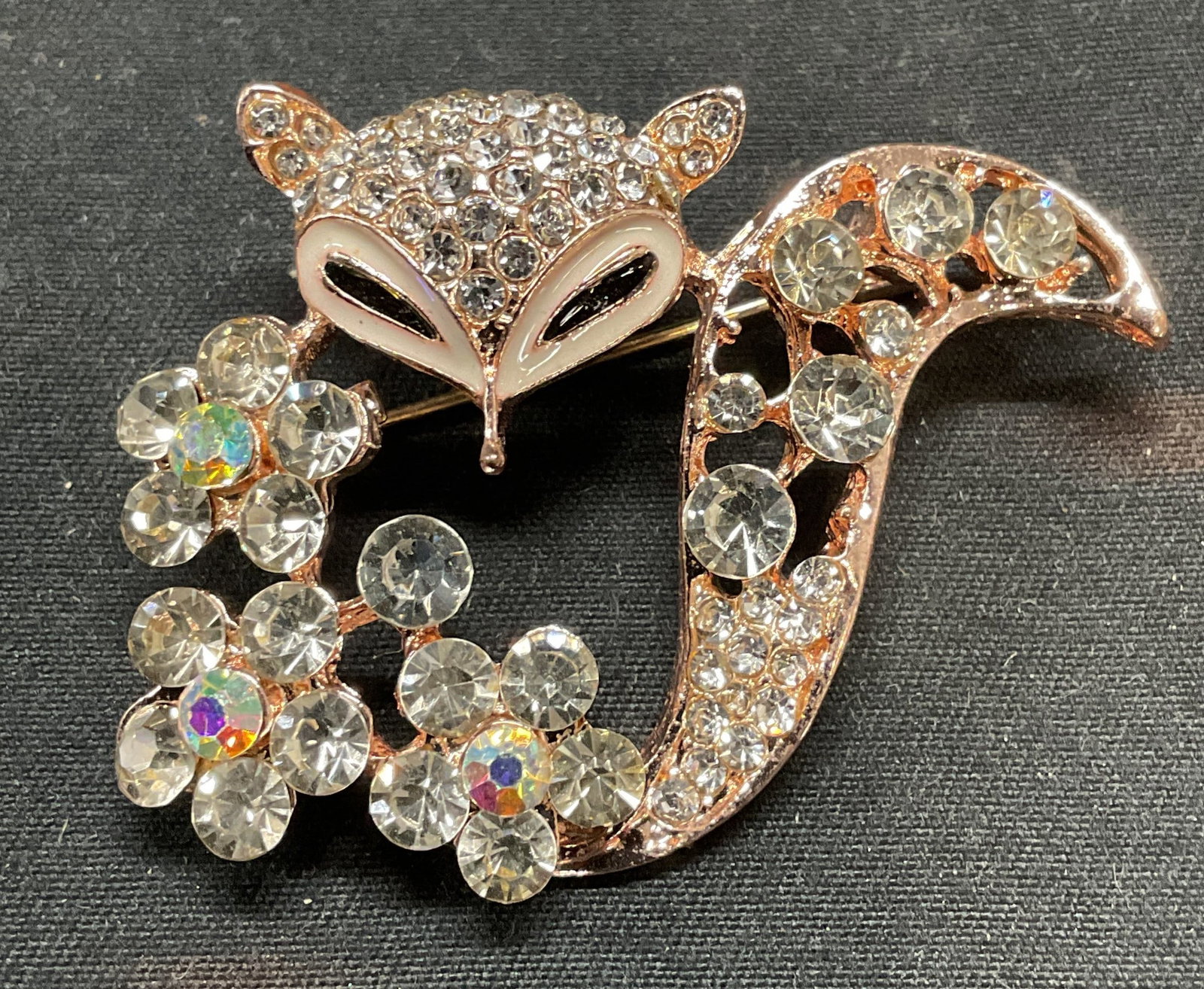 Gold Tone Crystal Fox & Flower Brooch: Gold tone fox and flower motif brooch with colorless crystal decoration. Hinge pin on underside. Measures approx. 1.5 x 1.75 inches. Some surface wear including scratching observed. Jewelry, estate je