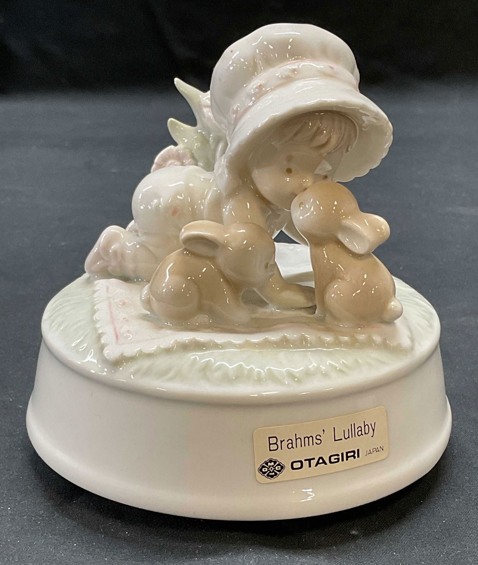 Vtg OTAGIRI Baby Porcelain Music Box: Vintage Otagiri porcelain music box. Brahms Lullaby. Baby and rabbit motif. Signed on underside. Made in Japan. Measures approx. 4 x 4 inches. Not tested for function. Some surface wear consistent wit