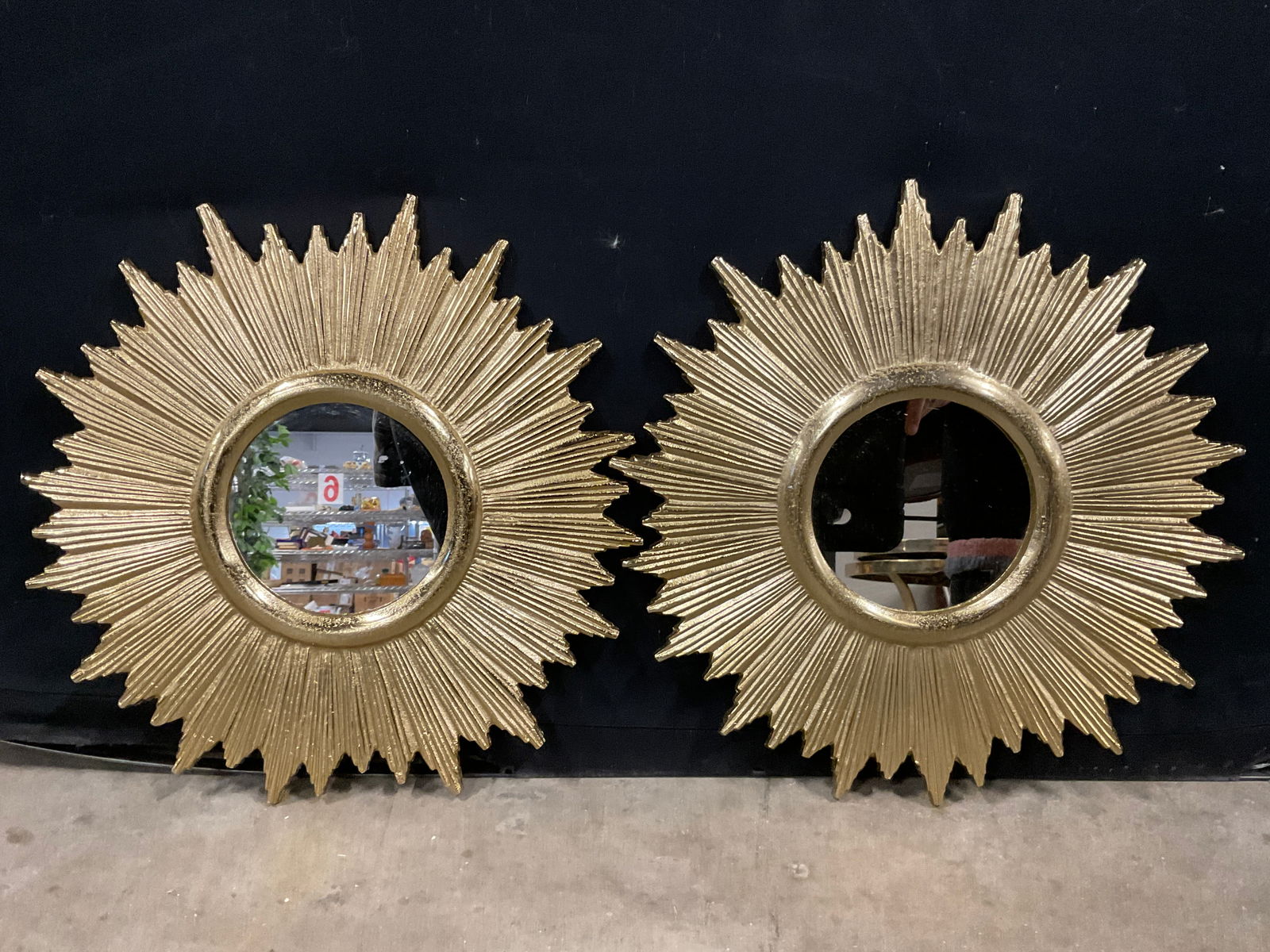 Pair Gold Tone Metal Sunburst Mirrors: A pair of gold tone metal sunburst mirrors. Measures approx. 14.5L x 14.5W in. Metal hardware to reverse for display. Surface wear consistent with age, use, and exposure. mirrors, wall mirror, home de