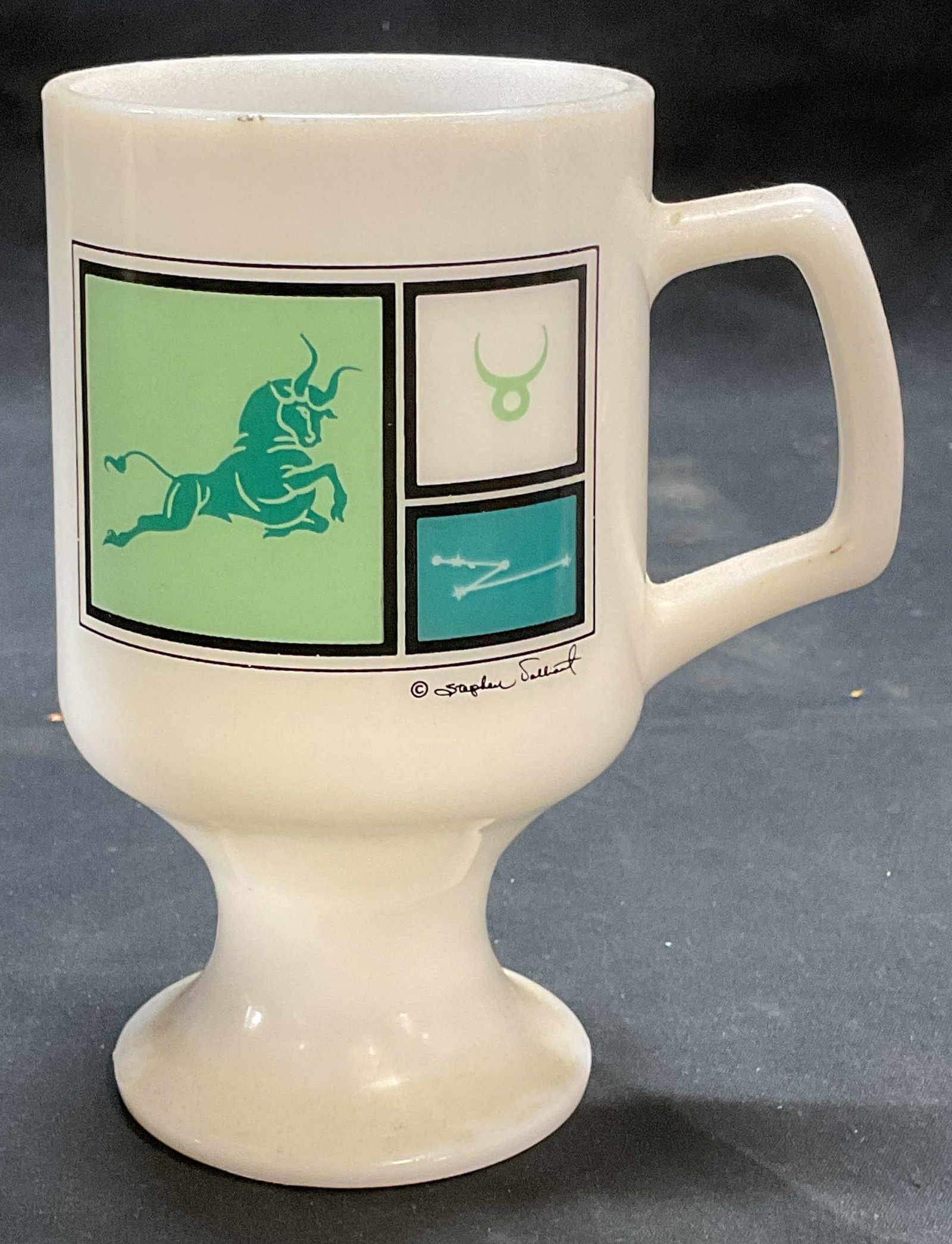 Vintage Motorola Bullish Milk Glass Mug: Vintage Motorola advertising mug. Milk glass. Bulk optic on front, reads Motorola is bullish on low power Schottky on reverse. Measures approx. 3.25 x 5.75 inches. Some surface wear consistent with ex
