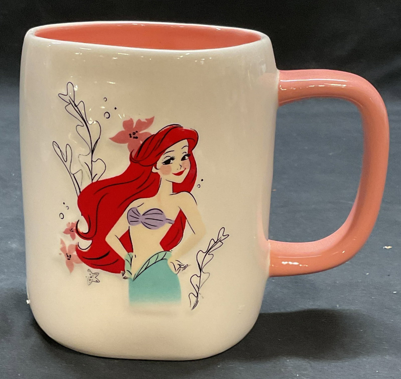 Rae Dunn Disney Little Mermaid Ceramic Mug: Rae Dunn Disney Princess Ariel Little Mermaid ceramic mug. Signed on underside. Measures approx. 3.75 x 4.75 inches. Some surface wear including scratching observed. Rae Dunn, Disney Princess mug, Dis