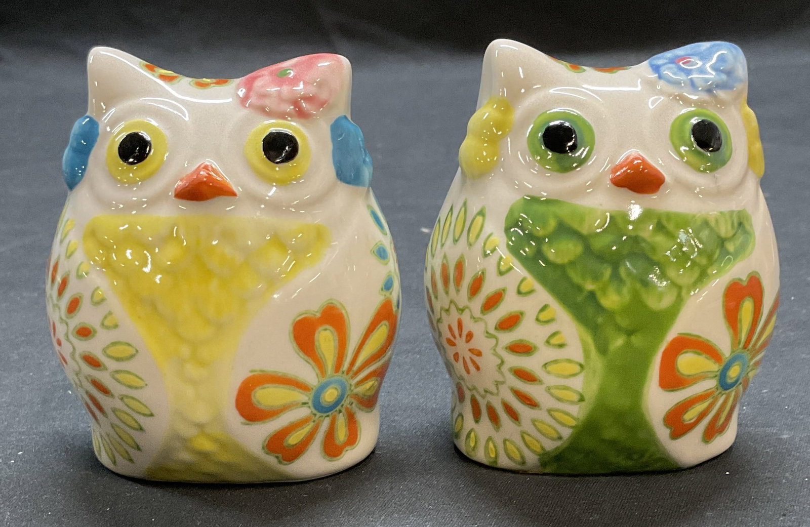 Pair Pier 1 Ceramic Owl Salt & Pepper Shakers: Pier 1 ceramic owl motif salt and pepper shakers with hand painted floral design. Signed P1 on undersides. Measures approx. 2.25 x 1.75 x 3 inches each. Both pieces have some surface wear including sc
