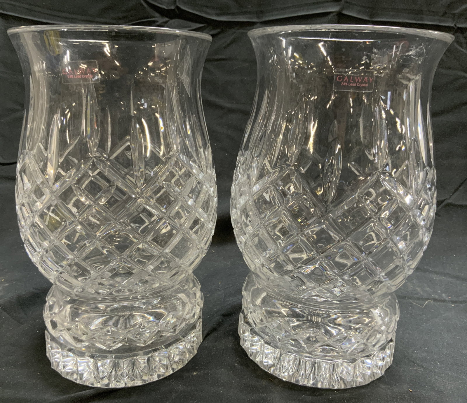 GALWAY Pair Crystal Hurricanes Vessels W Bases: Vessels & bases each read GALWAY. Heavy cut crystal hurricane Vessels and bases are all Lead Crystal. Vessels each have diamond form relief detail. Vessels with bases each measure approximately 9 inch