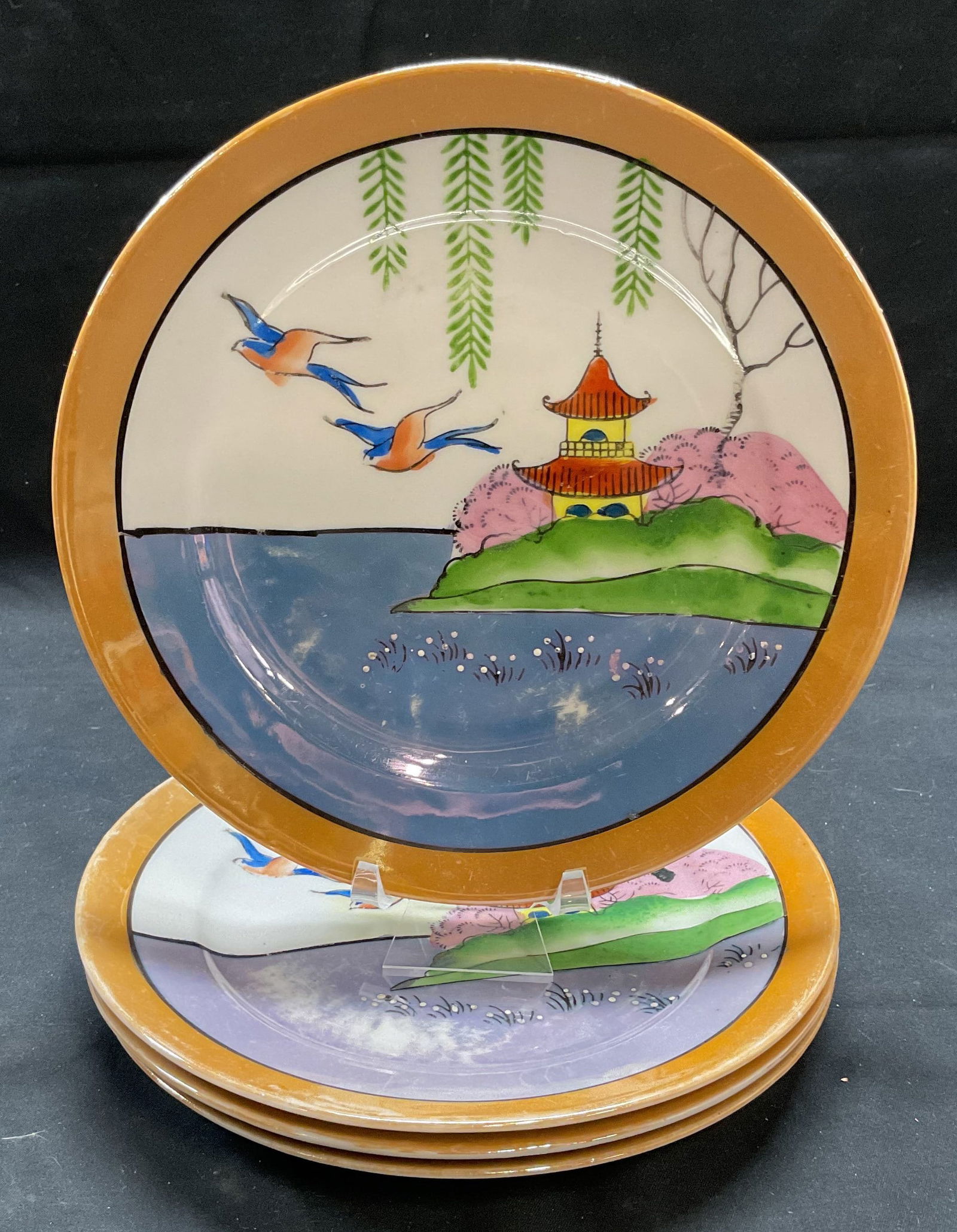 Set 4 Vintage Porcelain Lustreware Plates, Japan: Set of 4 vintage porcelain lustreware plates. Hand painted bird and pagoda landscape design. Made in Japan. Measure approx. 7.25 inches each. Some surface wear to all pieces including scratching and l