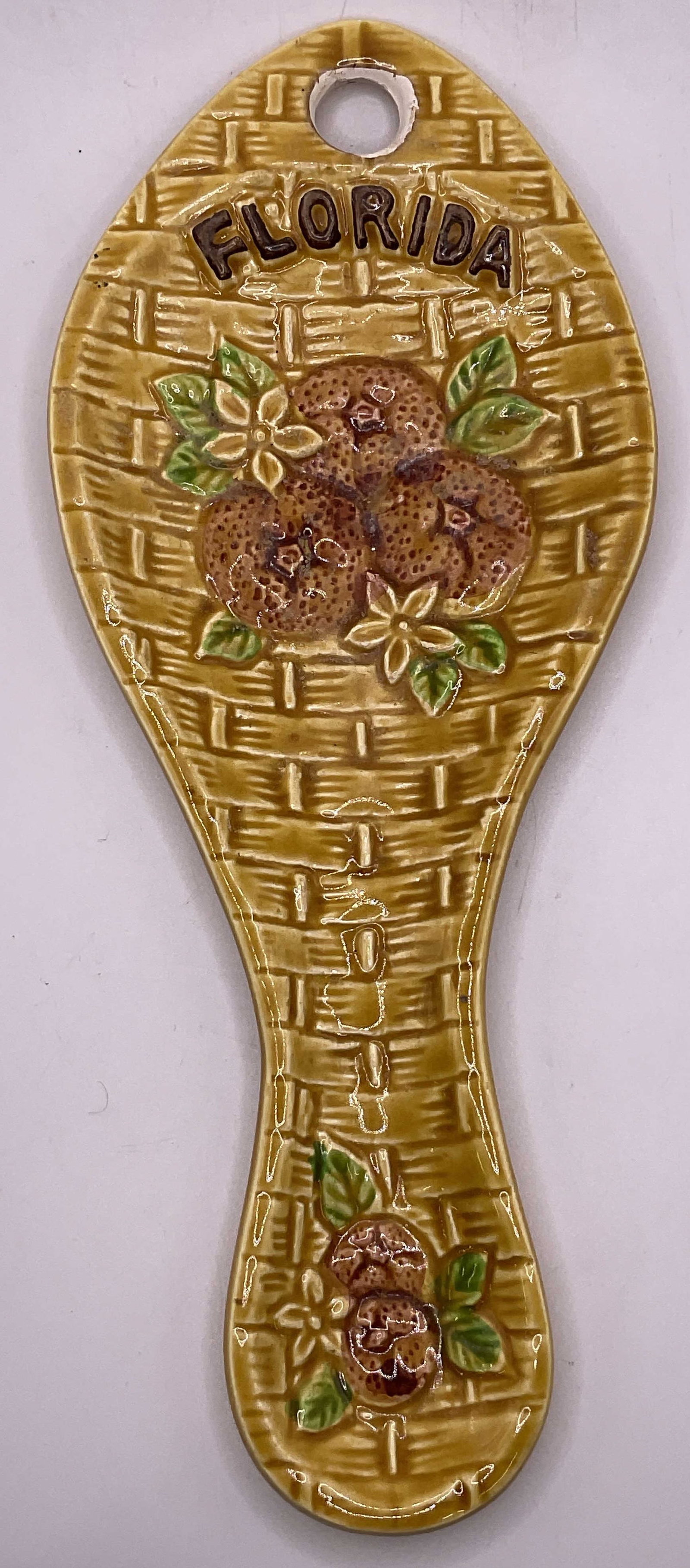 FLORIDA Ceramic Orange Motif Spoon Rest: FLORIDA Ceramic Orange Motif Spoon Rest. Measures approx. 8.5L x 3.5W in. Crazing, pitting, and losses to finish present. home decor, home accents, homewares, housewares, home accessories, collectible