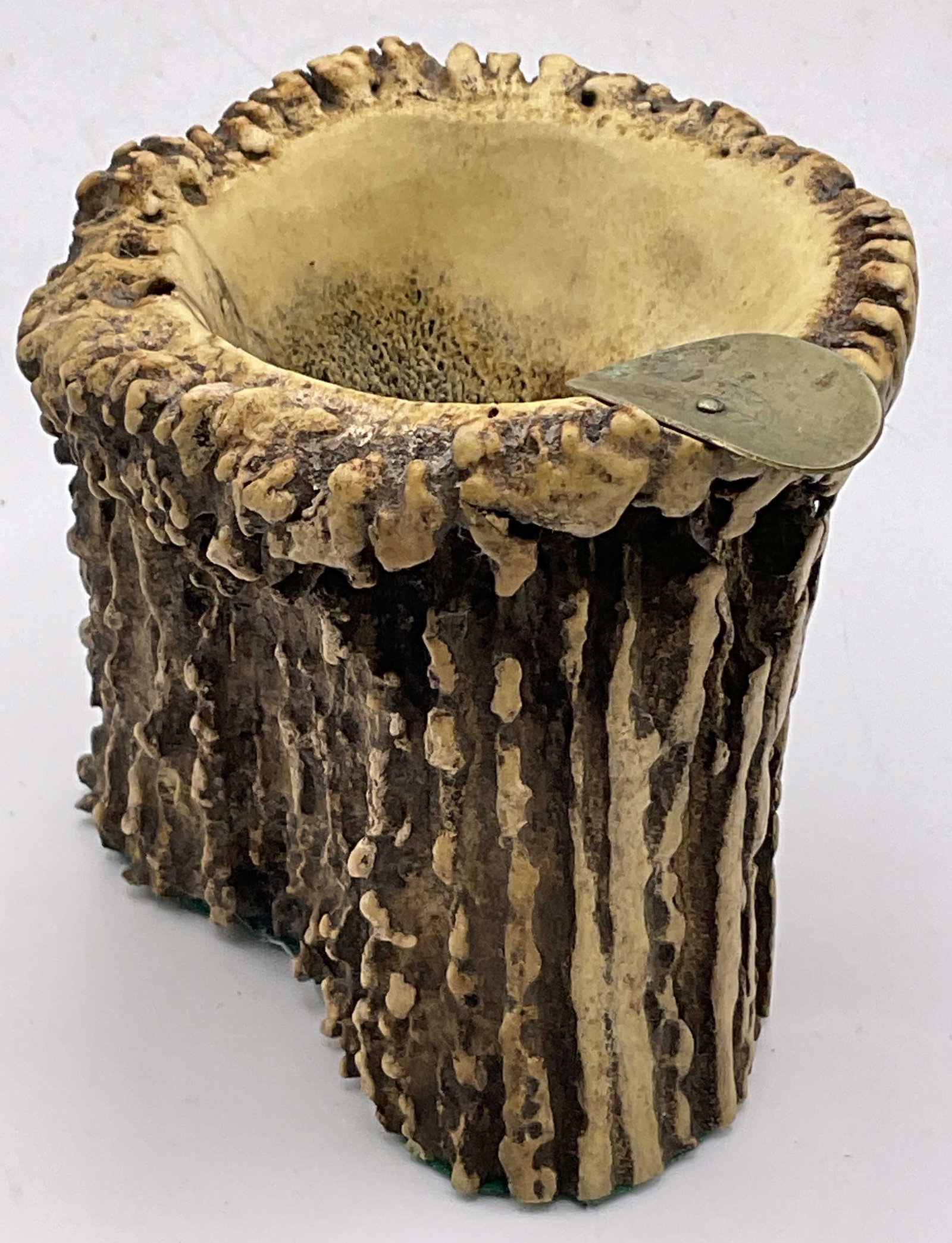 Stag Horn Ashtray / Trinket Dish: A stag horn ashtray / trinket dish. Metal rest to one side and green felt style material to the underside. Measures approx. 3H x 3W in. Appears to be a stag horn, possibly another animal horn. Losses 