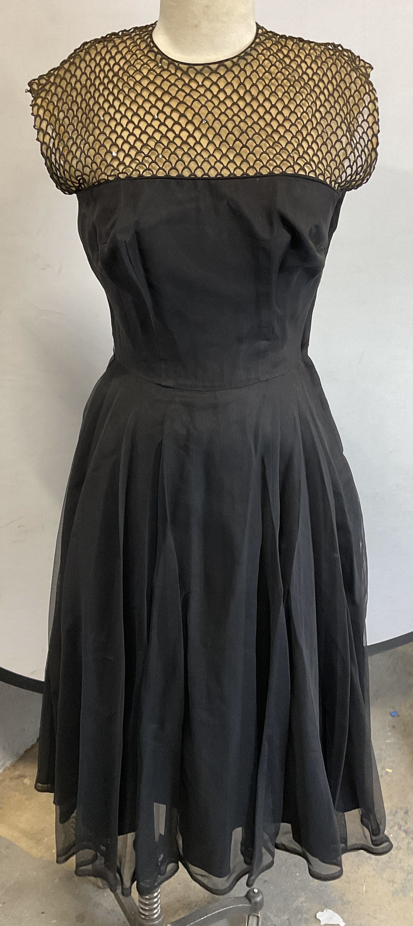 Vintage Black Sheer Scalloped Crystal Dress: Vintage sleeveless dress with black full length skirt and sheer nude scalloped pattern bust with crystal decoration. Measures approx. 16 inches across chest, 11 inches across waist, 45 inches from sho