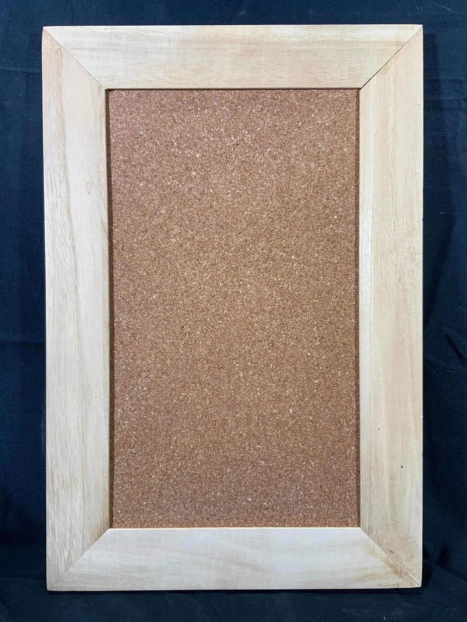 Framed Bulletin Cork Board Wall Hanging: Bulletin cork board. Framed in a light tan wooden frame. Frame measures approx. 12 W x 18 H in. Window measures approx. 8 W x 14 H in. Not viewed hanging. No major losses to cork board. Minor wear to