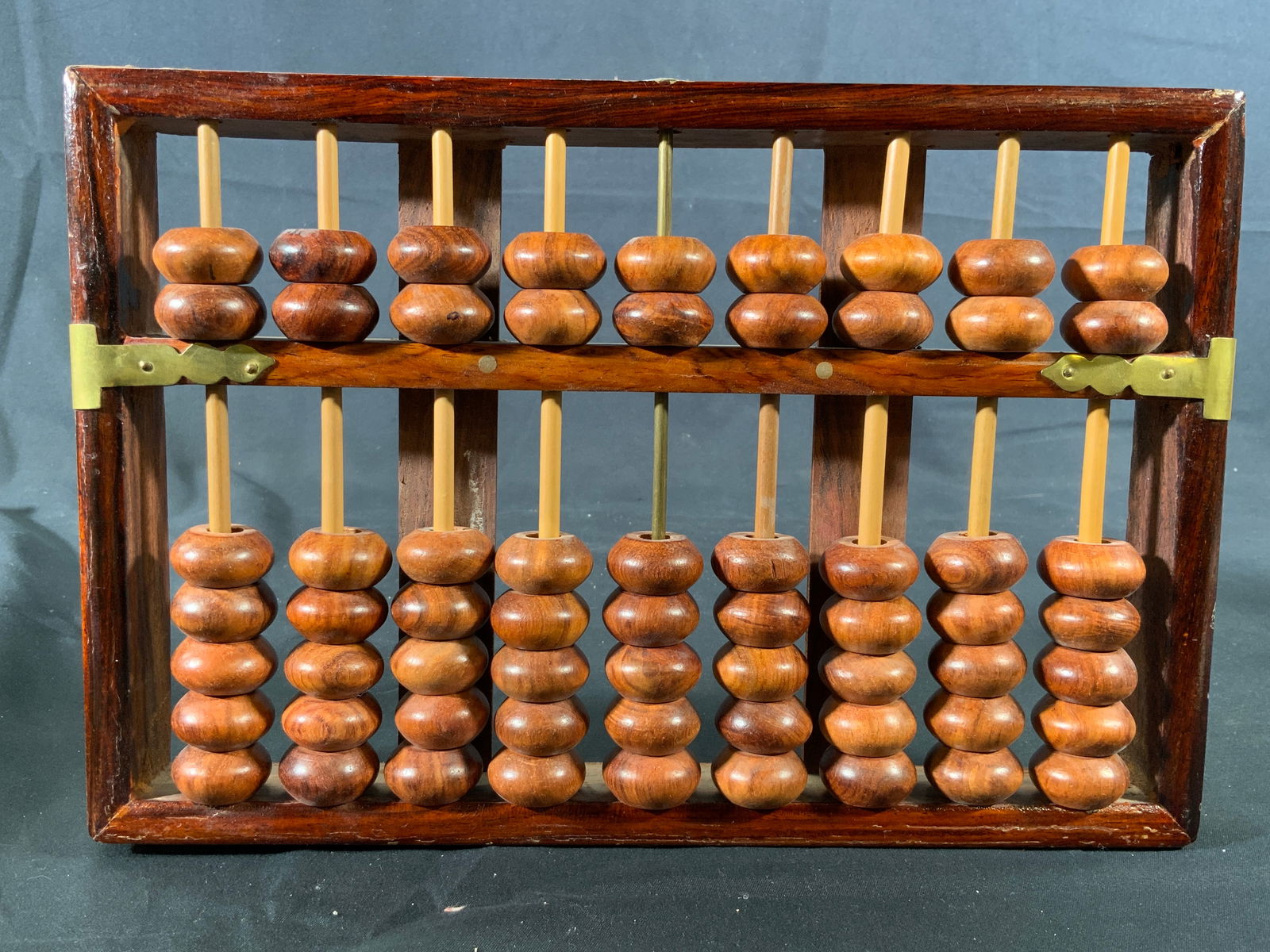 Lotus Flower Brand Huanghuali Asian Abacus: Asian wooden abacus. Lotus Flower Brand Huanghuali Asian abacus. 63 beads. Gold toned metal fastenings. Abacus measures approx. 11 W x 7 H in. Minor wear to wood. Wear to gold toned fastenings. Abacus