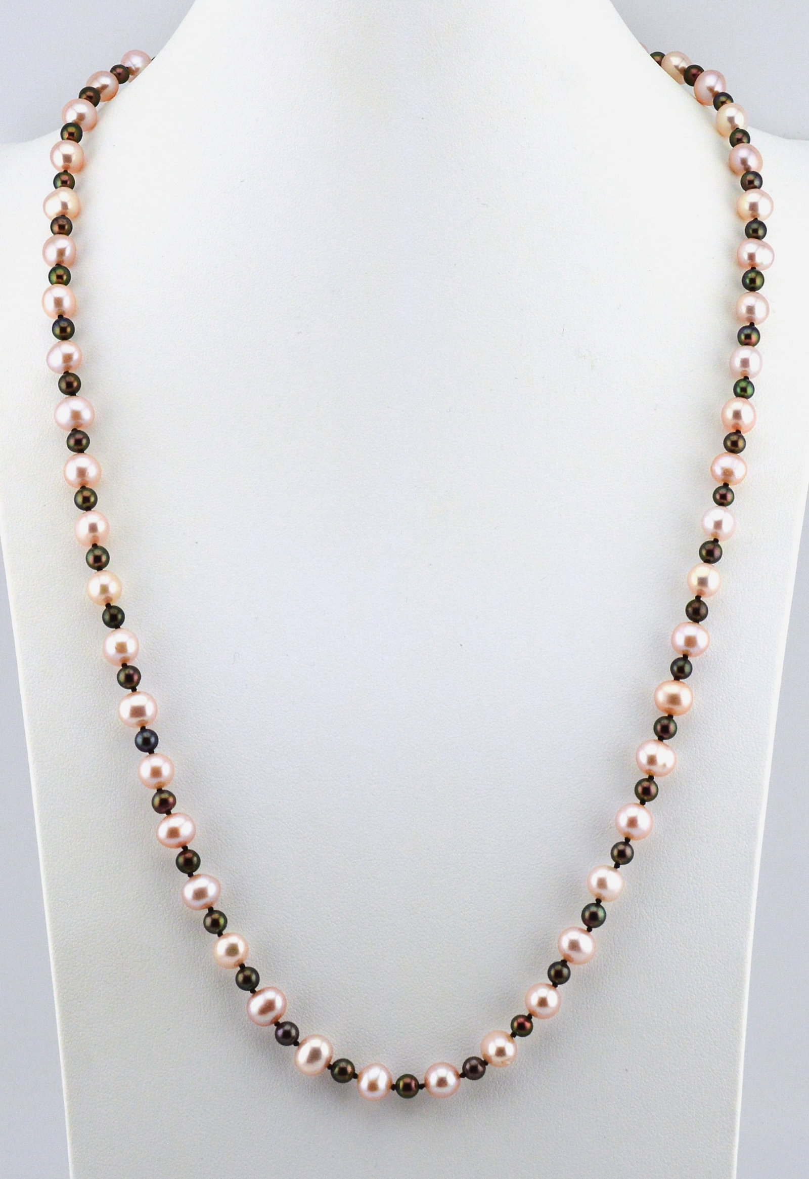 Handcrafted Designer Pink Pearl Necklace: Beautiful handcrafted pink freshwater pearls, iridescent beads and a sterling silver clasp with crystal. 48 7MM freshwater pink pearls. 50 4.25MM beads. 24 IN long.NEWBS11 J