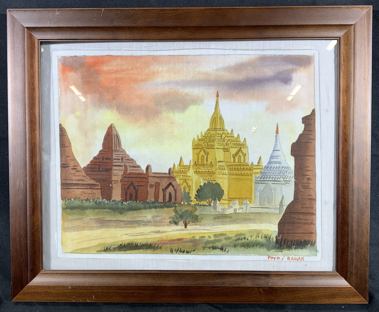 Framed & Signed Buddhist Temple Silk Watercolor: Watercolor on silk. Signed in lower right corner. Signature reads Phyd I Bagan. Subject depicts a landscape of a large Buddhist temple. Framed in a brown wooden frame. Frame measures approx. 16.5 W x