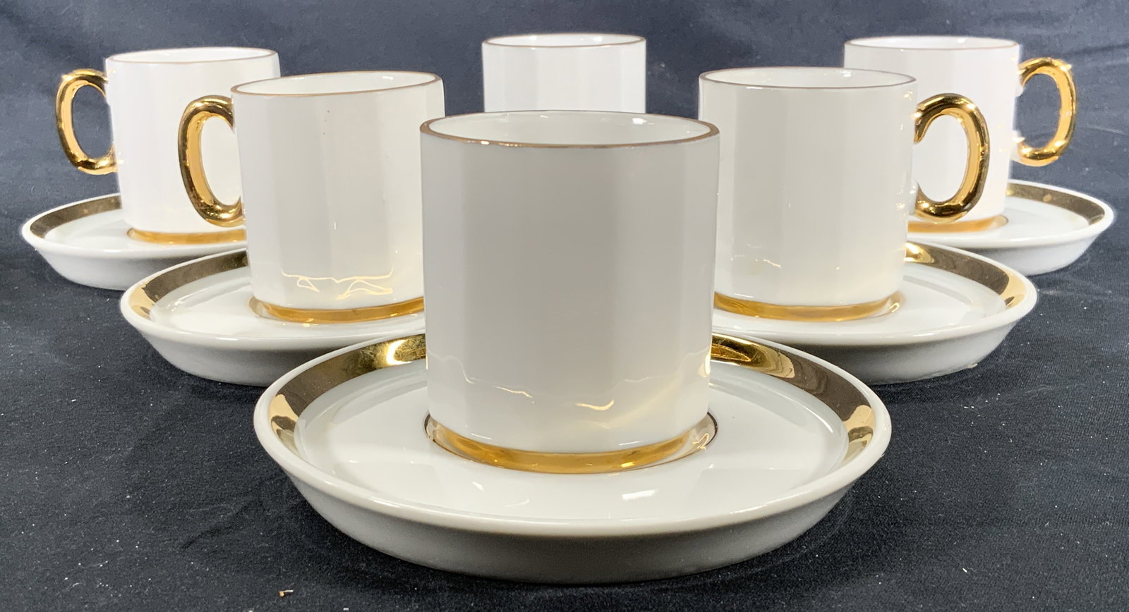 Lot 6 Ceramic Gilt Espresso Cups & Saucers: Lot 6 Ceramic espresso cups & saucers. Gilt accents to rims, saucers, borders, and handles. Cup measures approx. 2 H x 2 D in. Saucer measures approx. 4 D in. Minor wear to ceramic. Ceramic dishes, ce