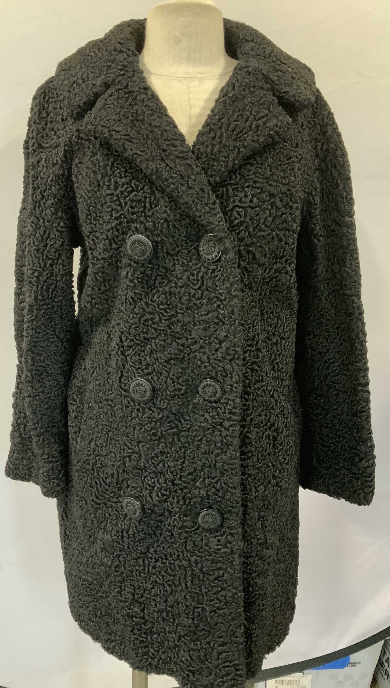 Curley Lamb Double Breasted Peat Coat: Curley lamb coat with decorative lining. Double breasted peat coat, 36 in. Waist. 35.5 in. Long. Embroidered name on lining reads Renee Cunningham. Hand pockets. Fur coat, winter coat, Curley lamb fur