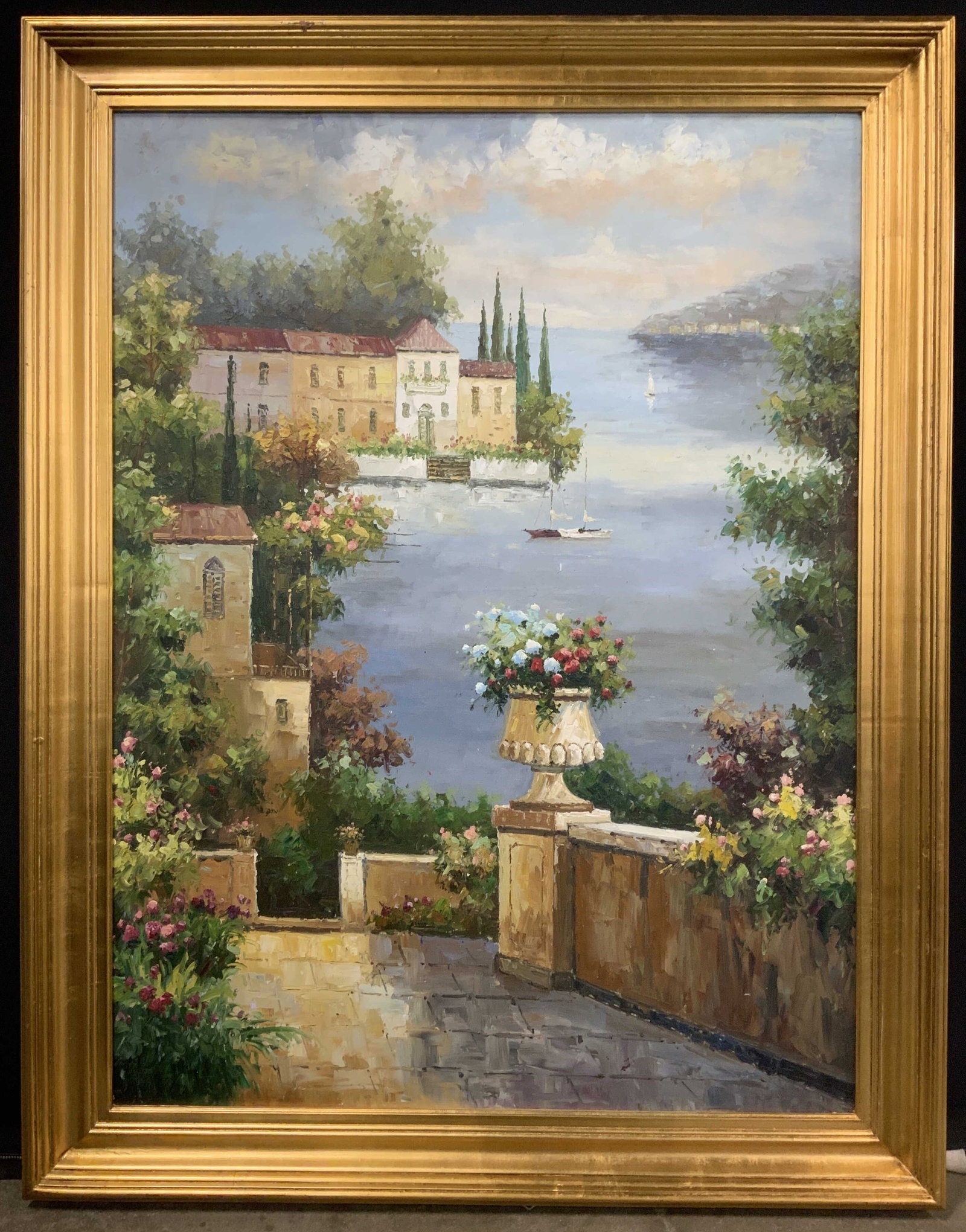 Framed Floral Mediterranean Coast Oil Painting: Oil painting on canvas. Subject depicts a stone walkway filled with flowers looking over a Mediterranean coastline. Framed in a gilt wooden frame. Frame measures approx. 44 W x 56 H in. Window measure