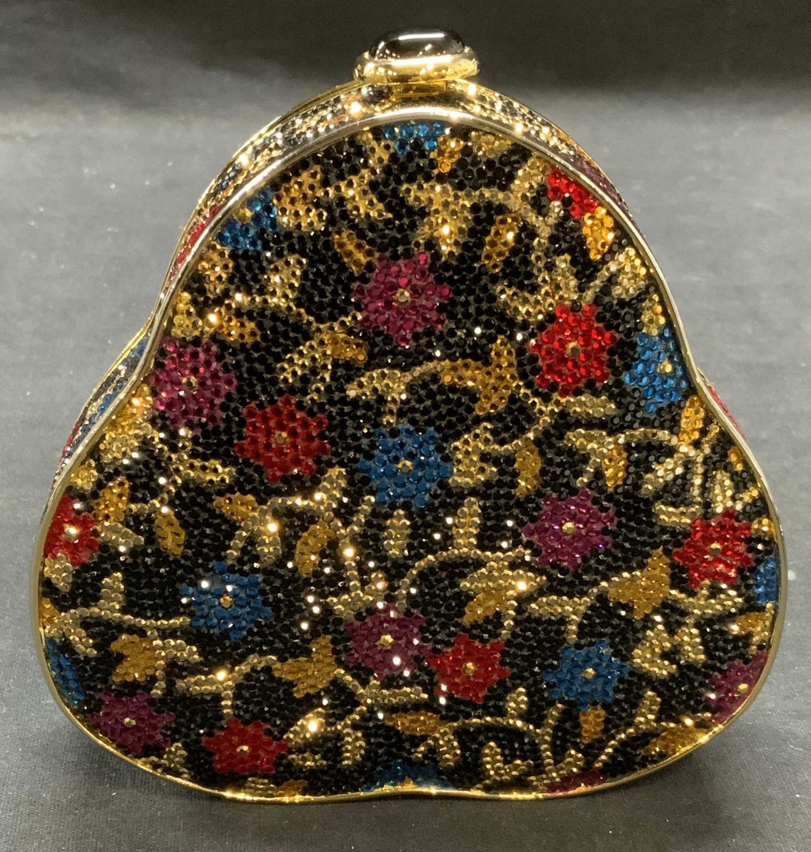 Vtg Judith Leiber Swarovski Crystal Minaudiere: Vintage Judith Leiber Swarovski crystal decorated minaudiere with chain strap. Floral and vine motif. Designer label to interior. Some missing rhinestones, overall good condition. Measures approx. 4 5