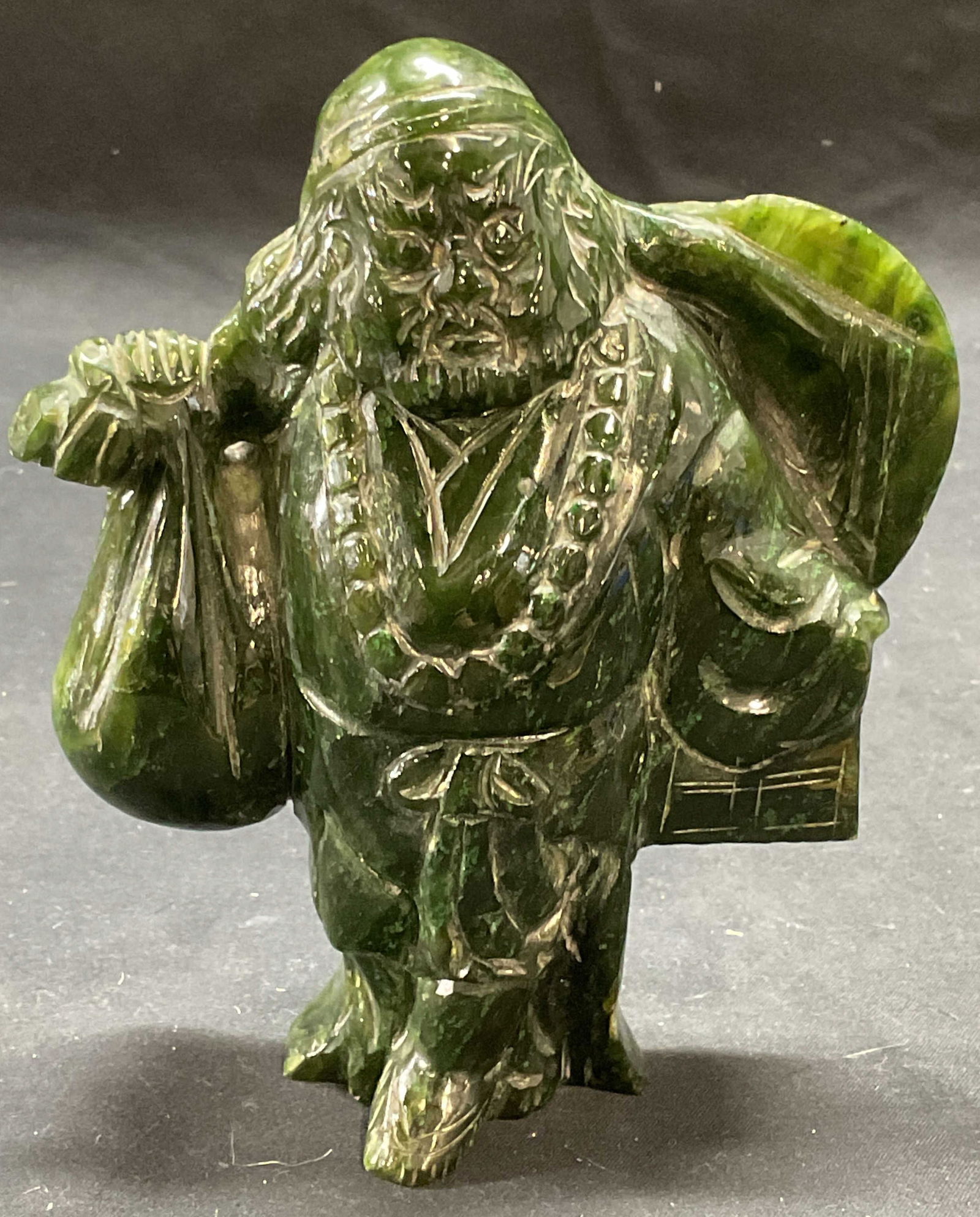 Vintage Chinese Carved Jade Figural: Vintage Chinese carved jade figural. Man holding sack, box, and hat. Measures approx. 4 x 1.75 x 5.5 inches. Piece has weight. Some surface wear including scratching observed. Chinese jade figural, Ch