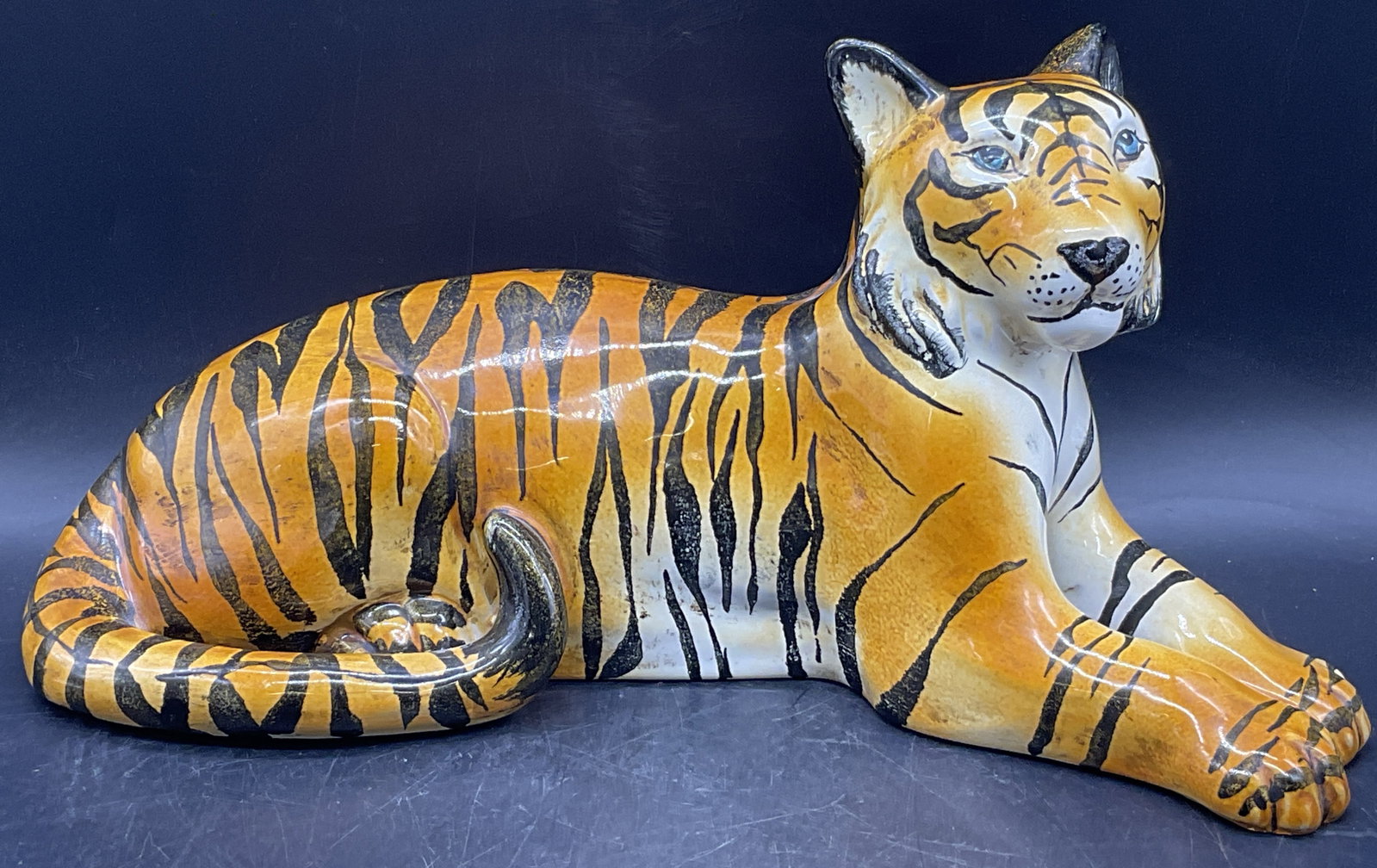 Handmade Pottery Tiger Figural, Italy: A thick walled and weighty handmade pottery tiger figural. Underside sticker reads HANDMADE IN ITALY. Measures approx. 7.5H x 15W in. Pitting, discoloration, and surface wear present. home decor, home