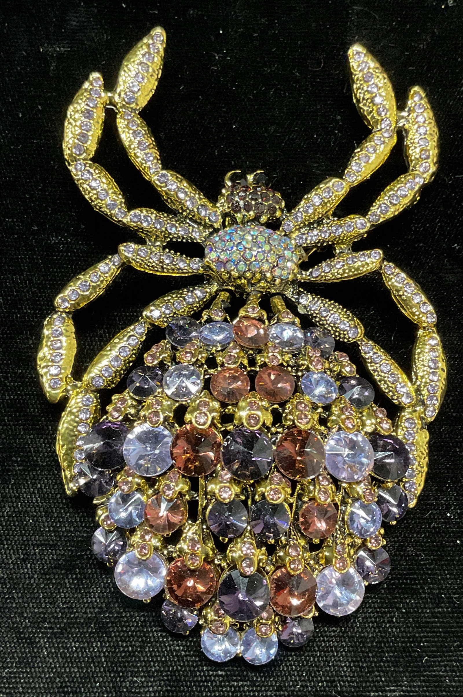 XL Gold Tone Crystal Spider Brooch Pendant: Gold tone spider motif brooch/pendant with purple crystal decoration. Hinge pin and bail on underside. Measures approx. 4.25 x 2.75 inches. Some surface wear including scratching observed. Jewelry, es