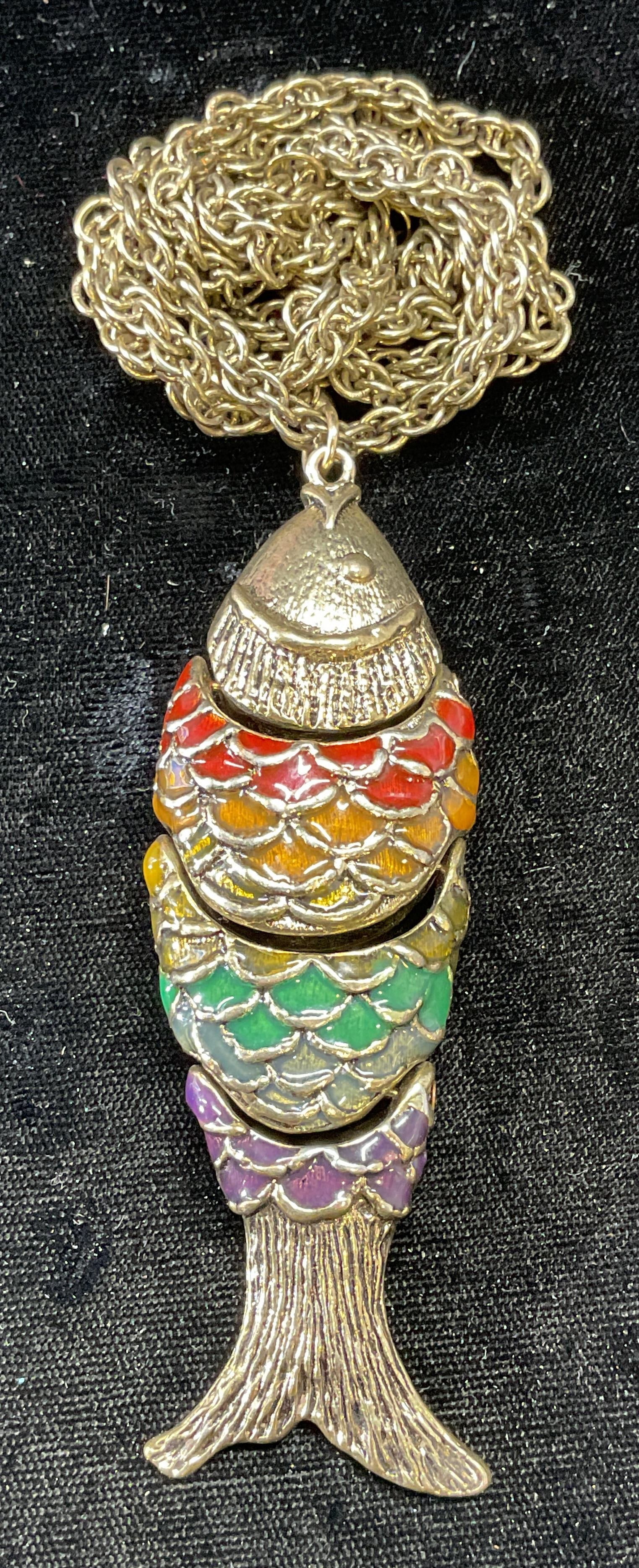 Articulated Gold Tn Fish Pendant Necklace: Gold tone chain necklace with articulated multicolor enameled fish motif pendant. Drop length approx. 16 inches. Pendant measures approx. 3.5 inches long. Some surface wear including scratching observ
