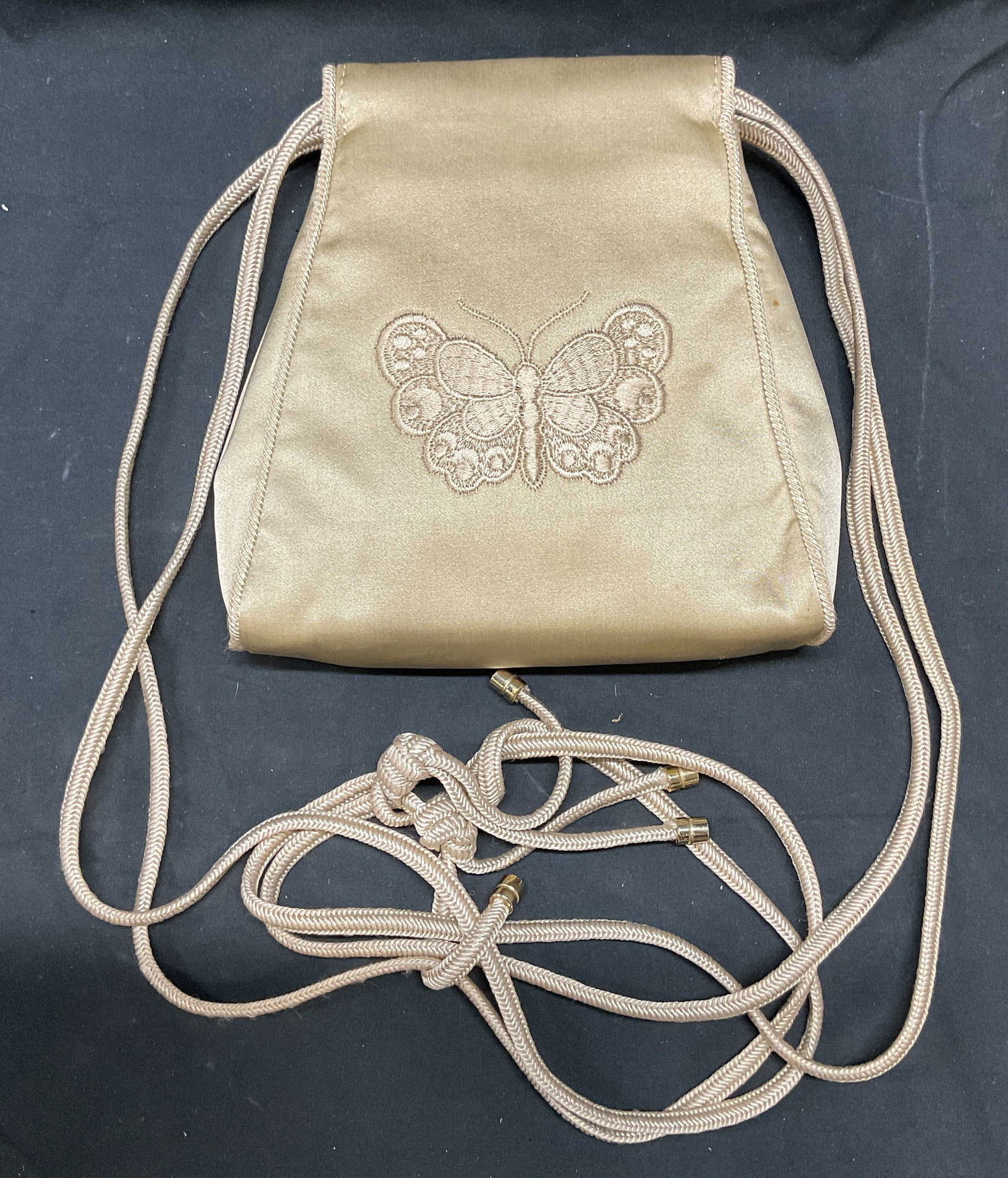 Bottega Veneta Bone Silk Butterfly Handbag Italy: Vintage Bottega Veneta bone silk handbag with embroidered butterfly design. Piping trim and double cord straps with gold tone capped ends. Signed on interior metal plaque. Made in Italy. Measures appr