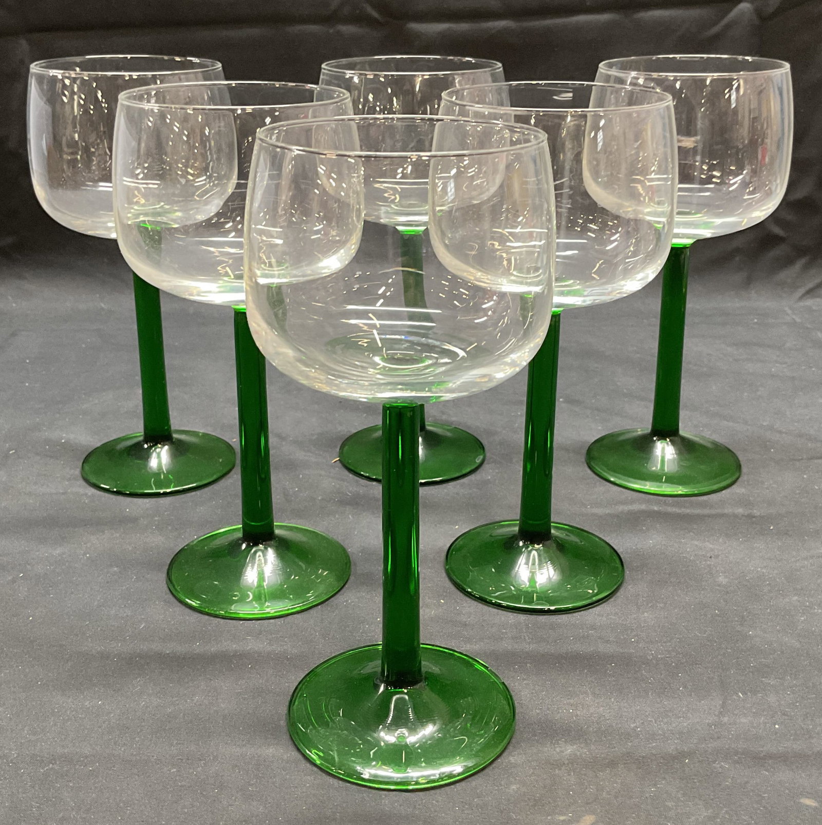6 Vintage Clear to Green Stem Wine Glasses, France: Set of 6 clear to green stem wine glasses with wide mouths. Made in France. Style of LUMINARC. Measure approx. 3.25 x 7.25 inches each. All pieces have some surface wear including scratching observed.
