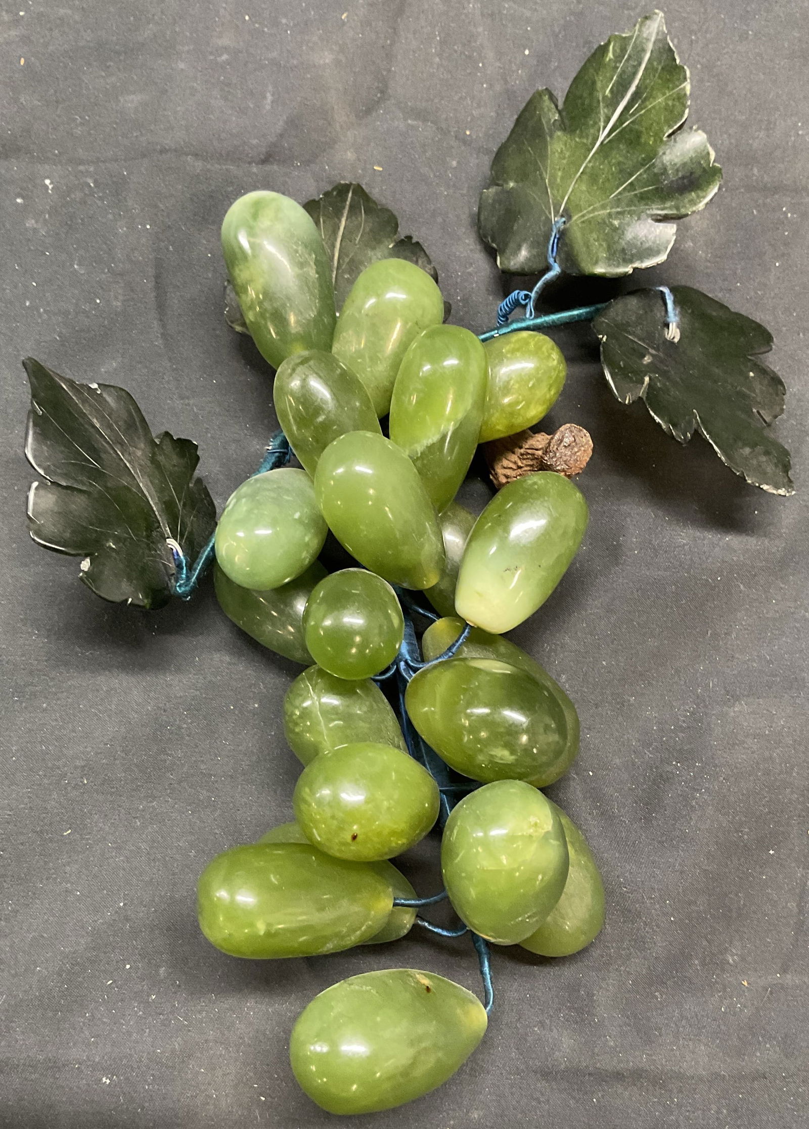 Carved Jade Grape Bunch Figural: Carved and polished jade grape bunch motif figural. Measures approx. 8 inches long. Total weight 592.7 grams. Some surface wear consistent with exposure. Jade, jade grape, jade grape bunch, grape figu