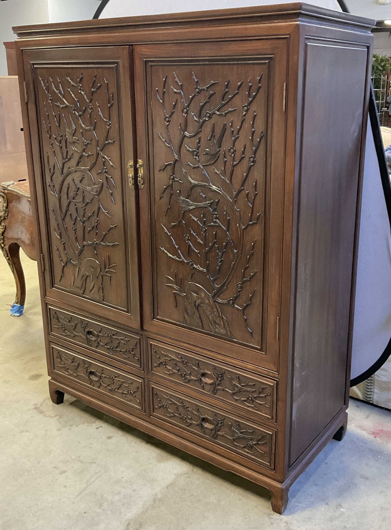 Vintage Carved Wood Bird & Foliage Motif Armoire: Vintage Carved Wood Bird & Foliage Motif Armoire. Doors open to reveal storage. Four drawers towards base. Brass hued metal hardware. Measures approx. 64H x 47.75W x 22D in. Doors need adjustment. Sur