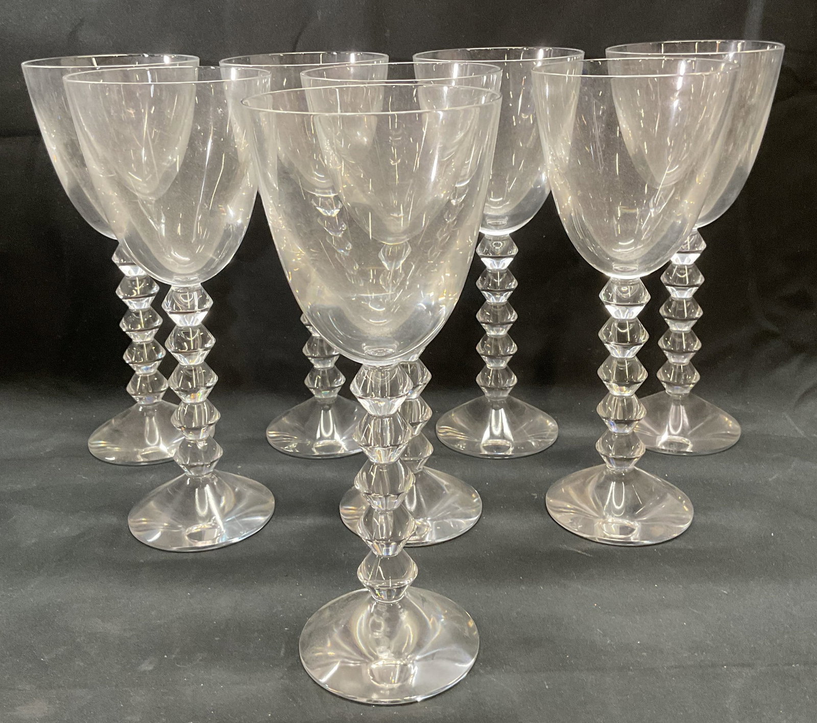 8 Baccarat Crystal Vega Wine Glasses, France: Set of 8 Baccarat crystal Vega wine glasses. Diamond shaped zigzag stems. Signed on bases. Made in France. Measure approx. 3.5 x 8.5 inches each. Glasses have weight. All pieces have some surface wear