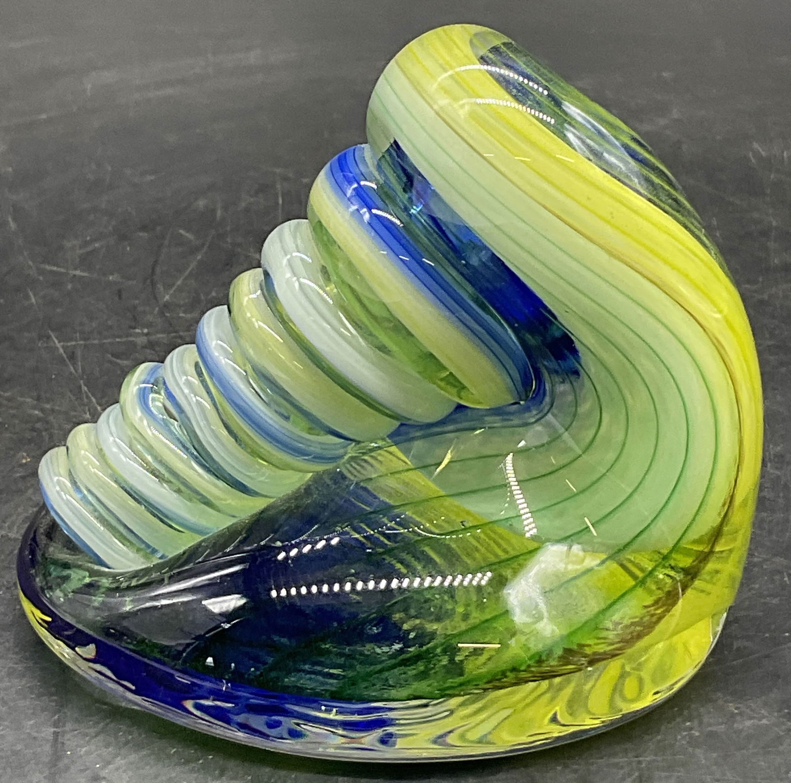 Yellow & Blue Art Glass Swirl Paperweight: Yellow & Blue Art Glass Swirl Paperweight. Measures approx. 3.25H x 3.5W in. Surface wear consistent with age, use, and exposure. Chipping and discoloration present. home decor, home accents, homeware
