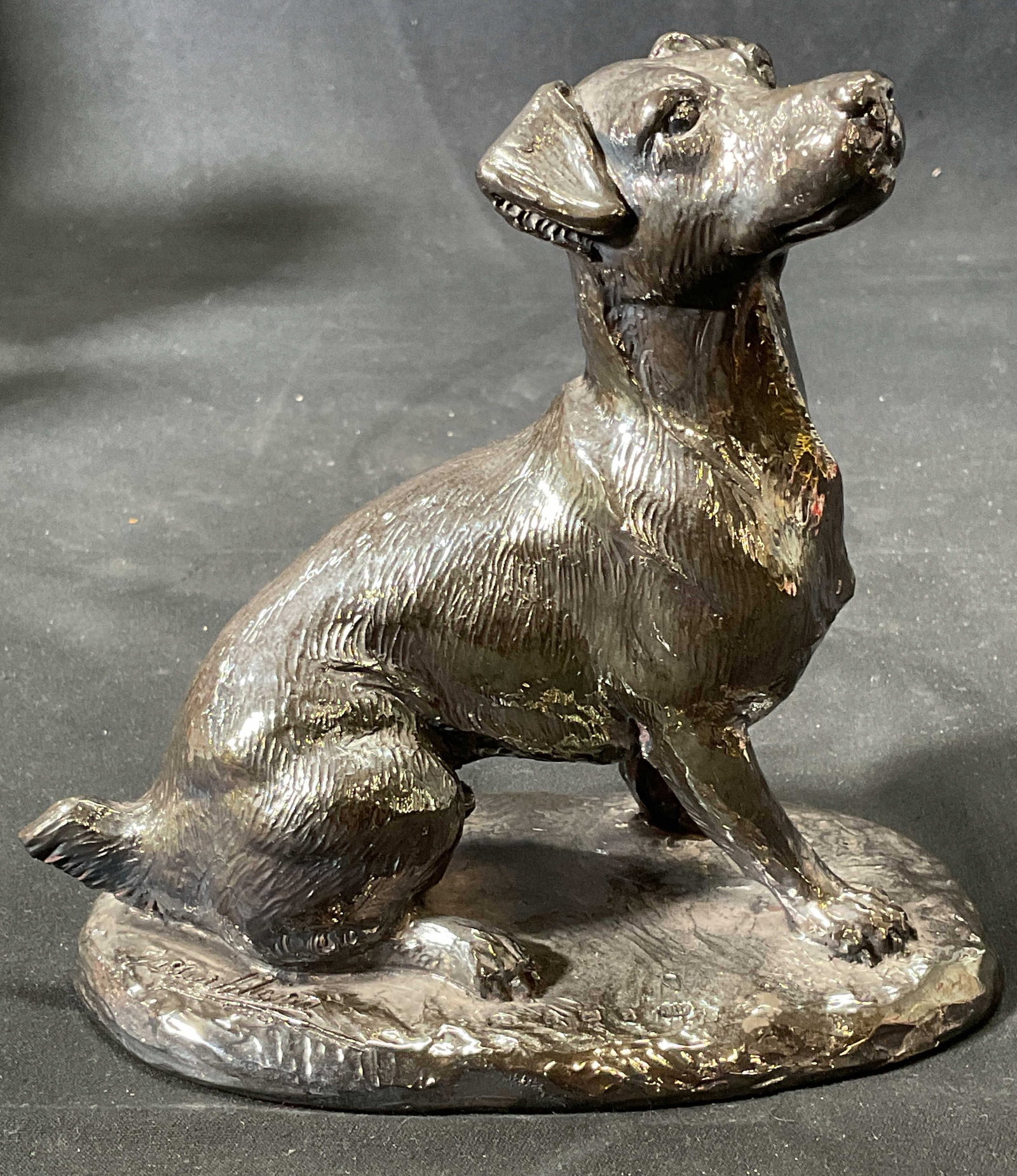 Signed Sterling Silver Dog Sculpture: Signed Sterling silver sculpture of a dog. Measures approx. 5.25 x 3 x 5.25 inches. Signed on base, illegible. Hallmarked on base, silver marks observed. Marked filled. Surface wear including patina o